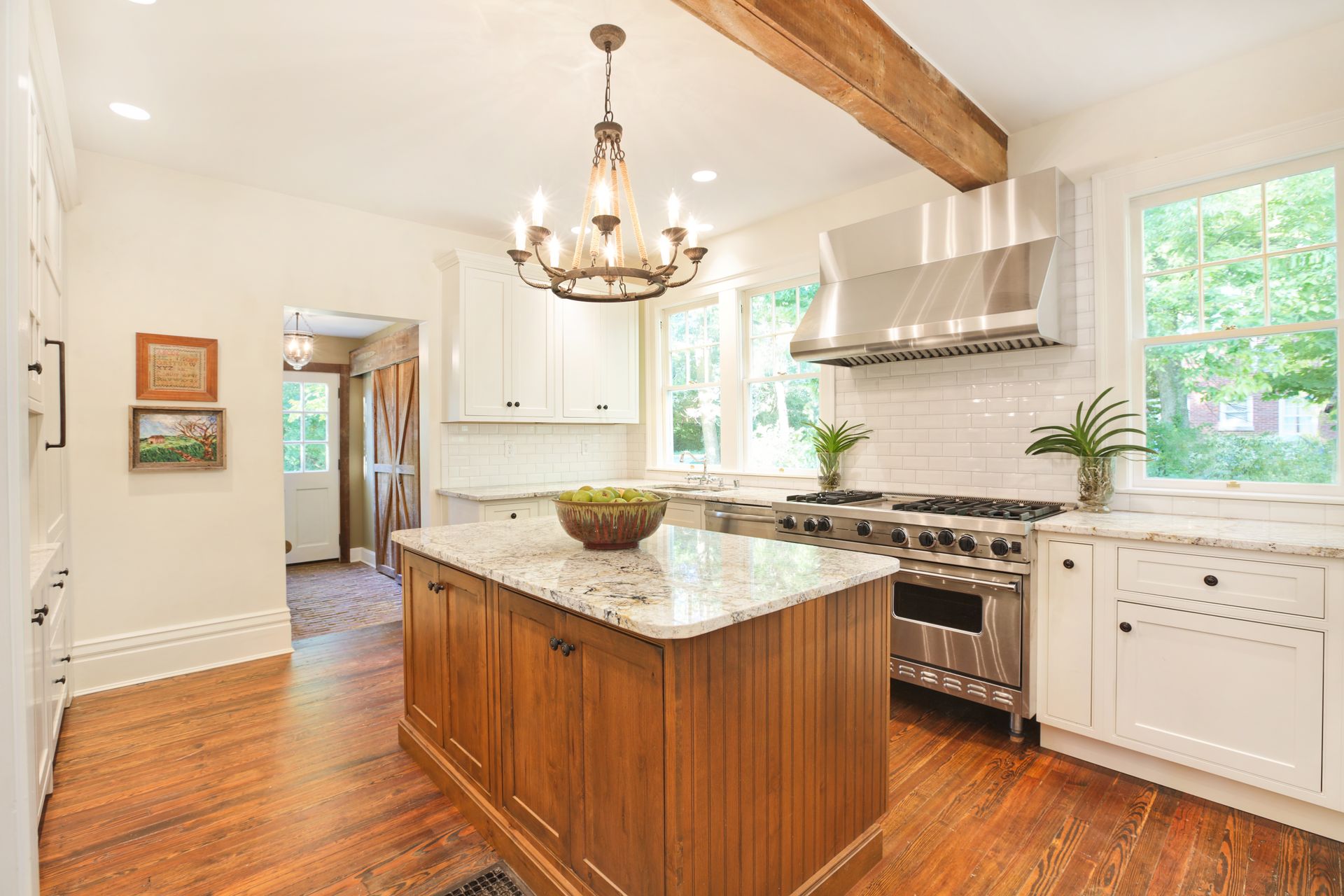 A kitchen with a large island in the middle and a stove.