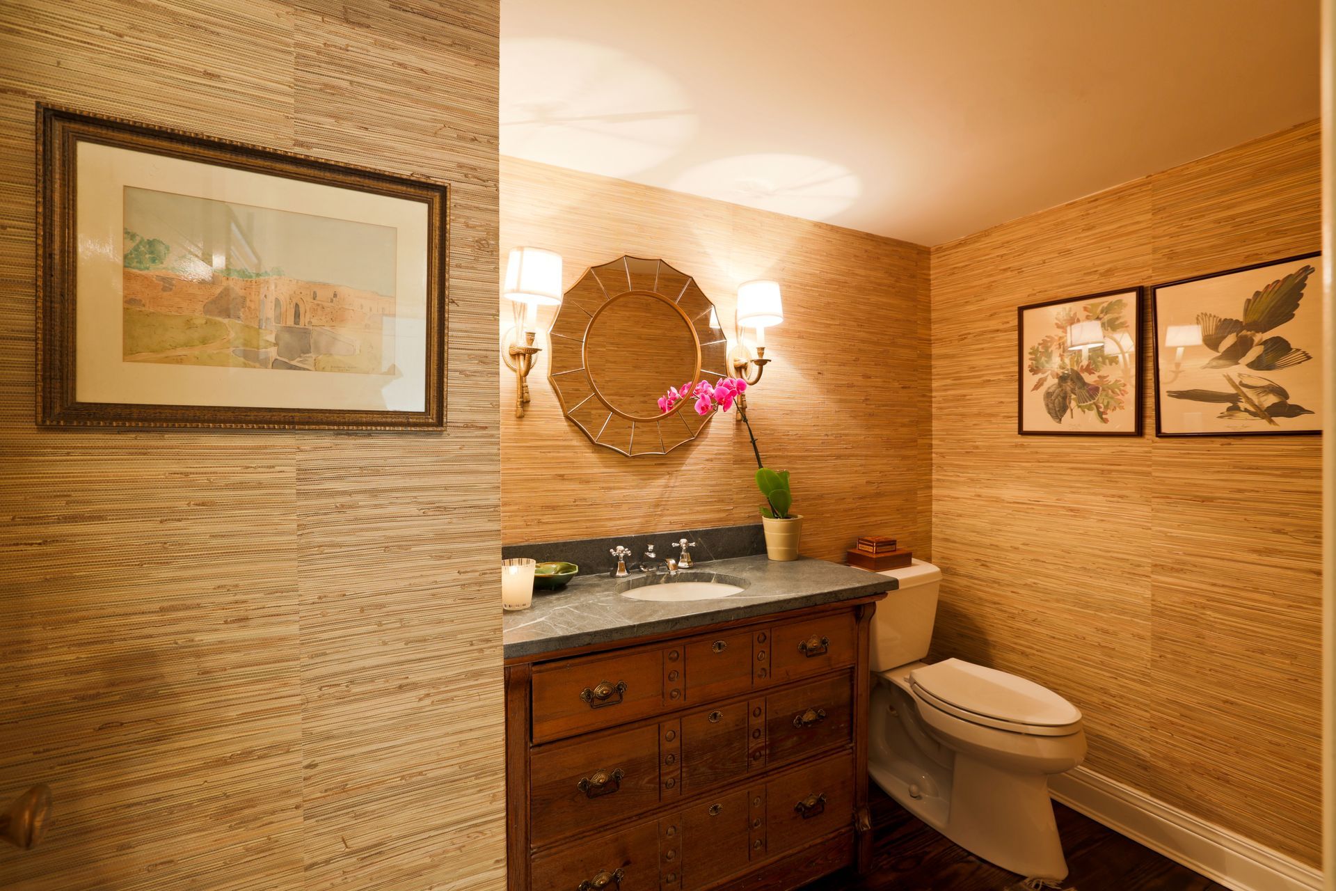 A bathroom with a sink , toilet and mirror.