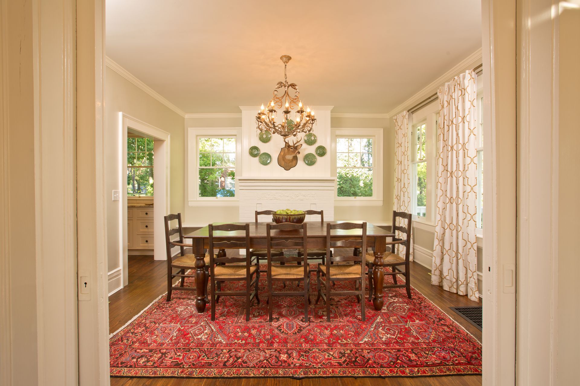 A dining room with a table and chairs and a rug