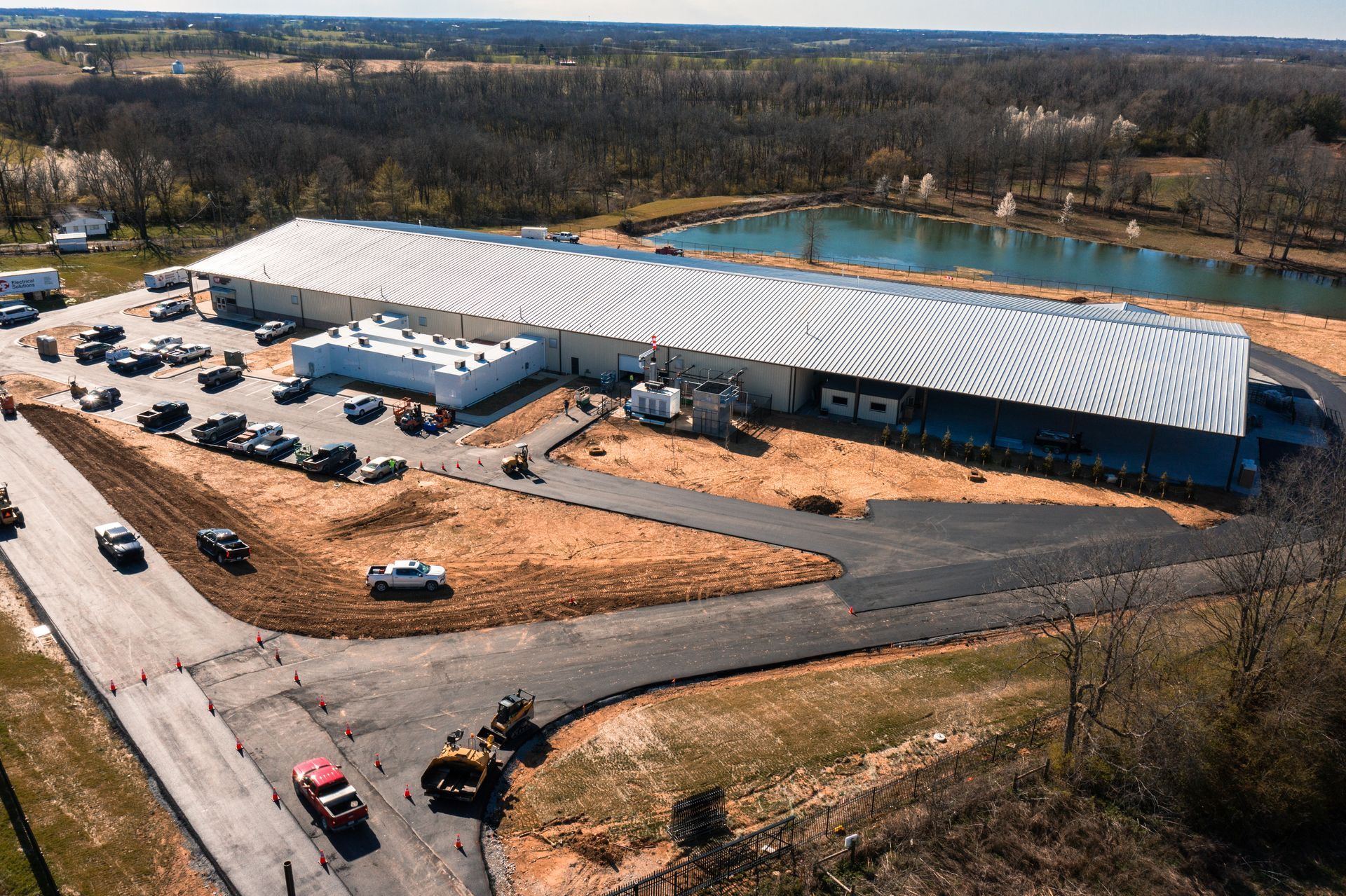An aerial view of a large building with a lot of cars parked in front of it.