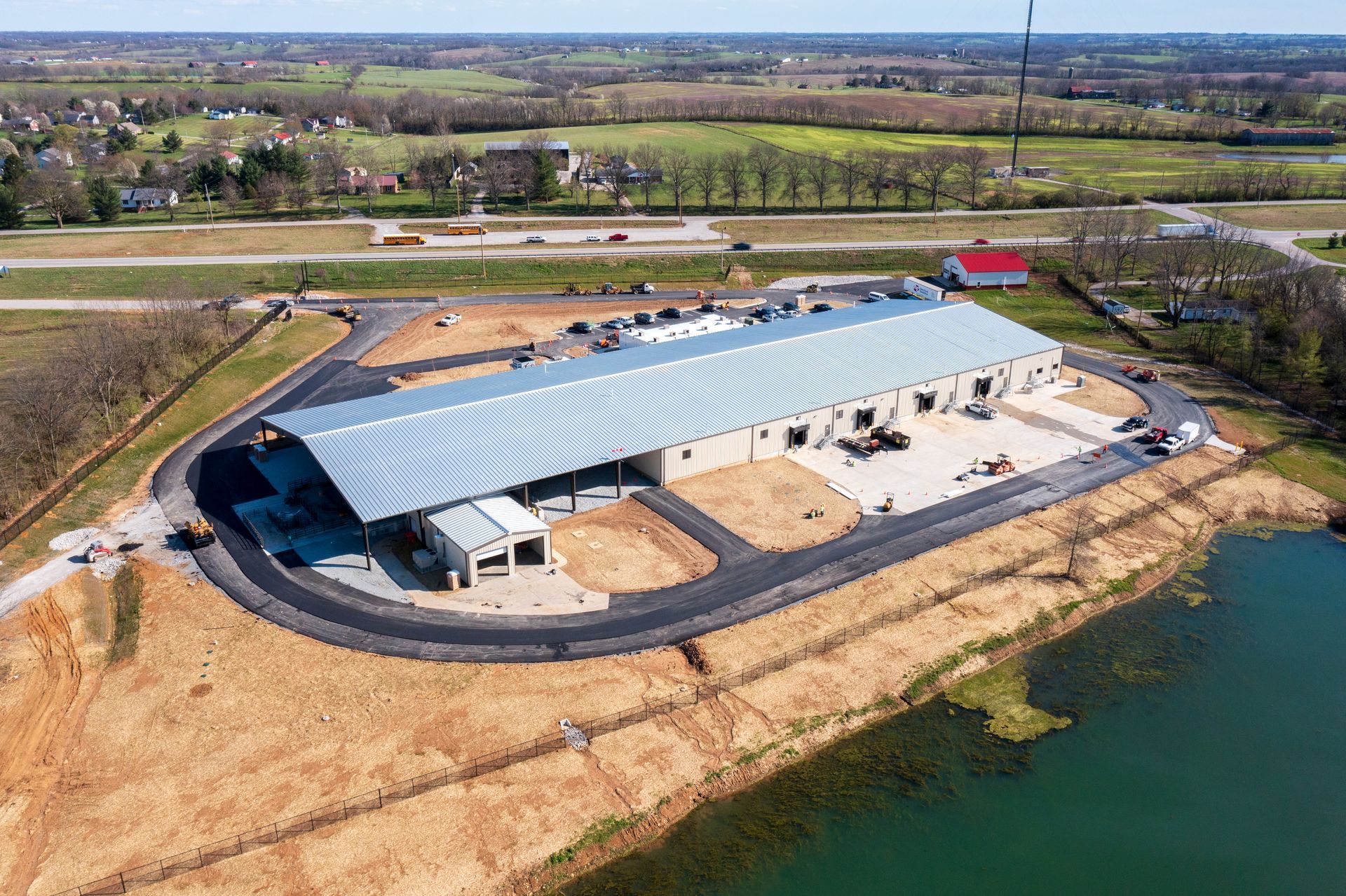 An aerial view of a large building next to a body of water.