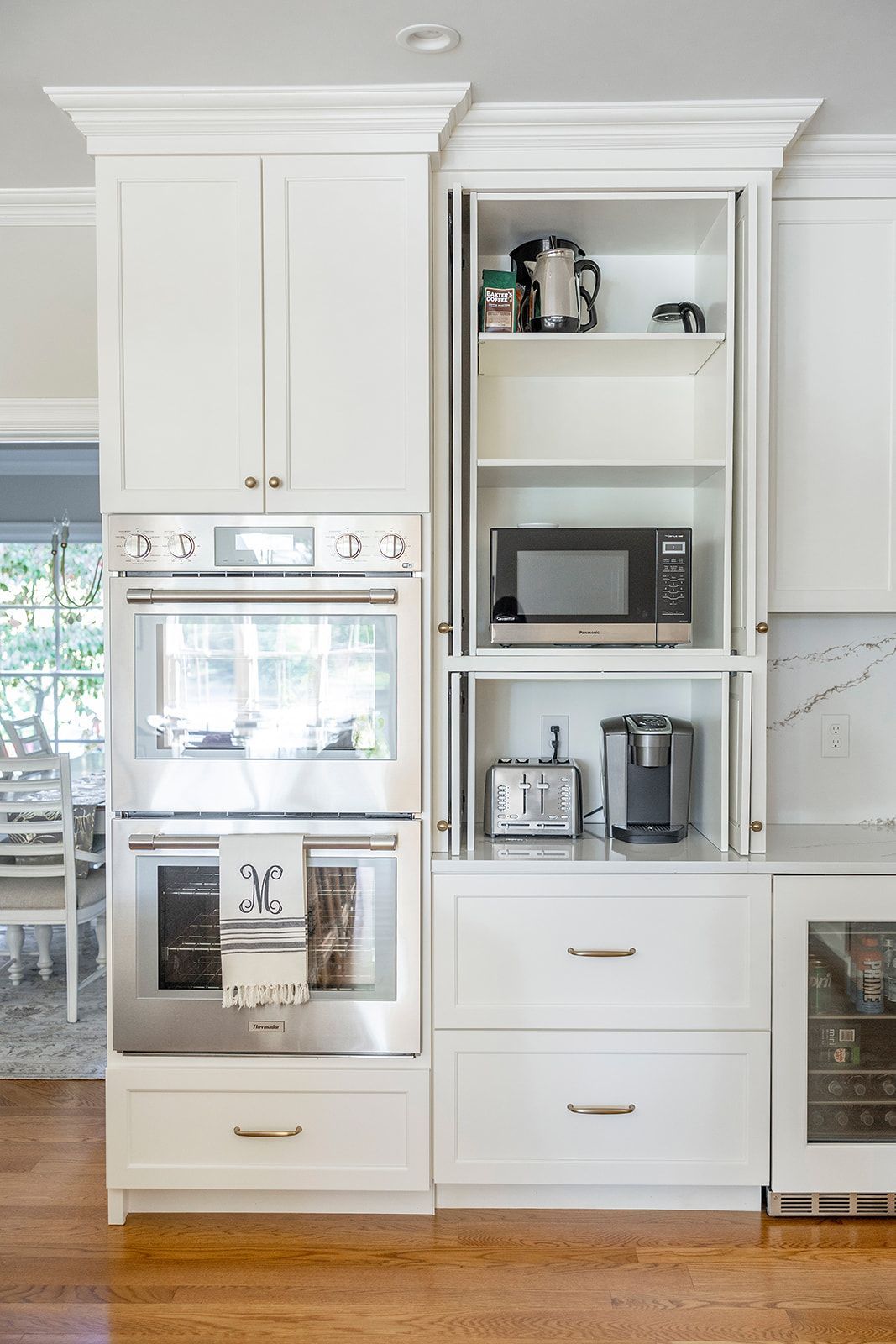 A kitchen with stainless steel appliances and white cabinets