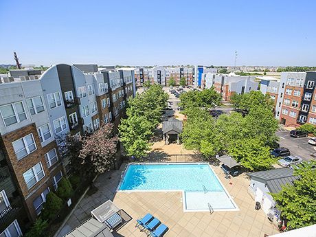 An aerial view of a large swimming pool surrounded by buildings.