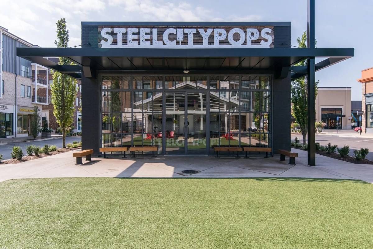 A bus stop with a sign that says steel city pops