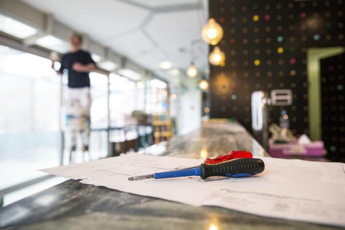 A screwdriver is sitting on top of a piece of paper on a counter.