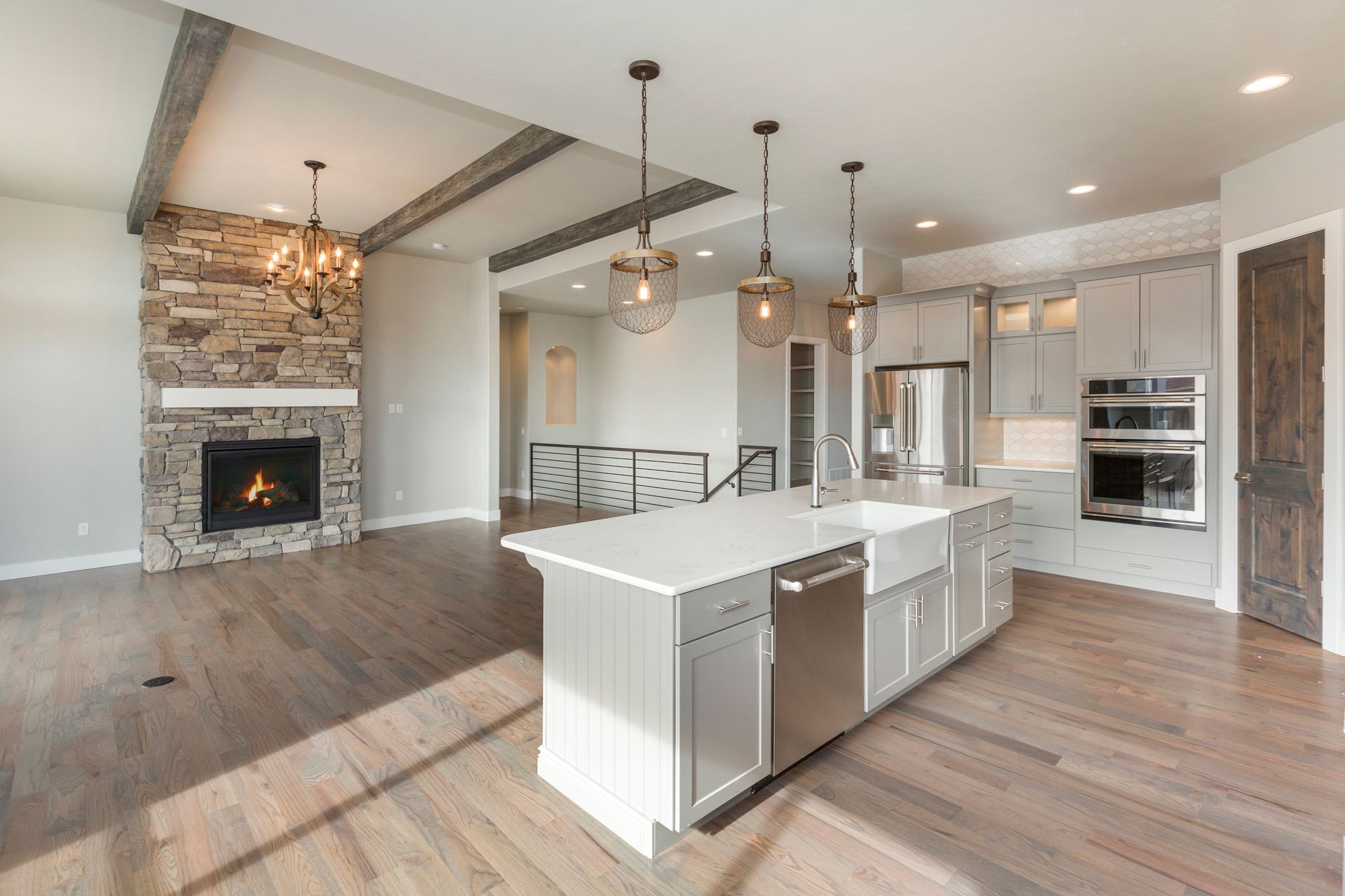 Remodeled kitchen with wood flooring, cabinets, and kitchen island.