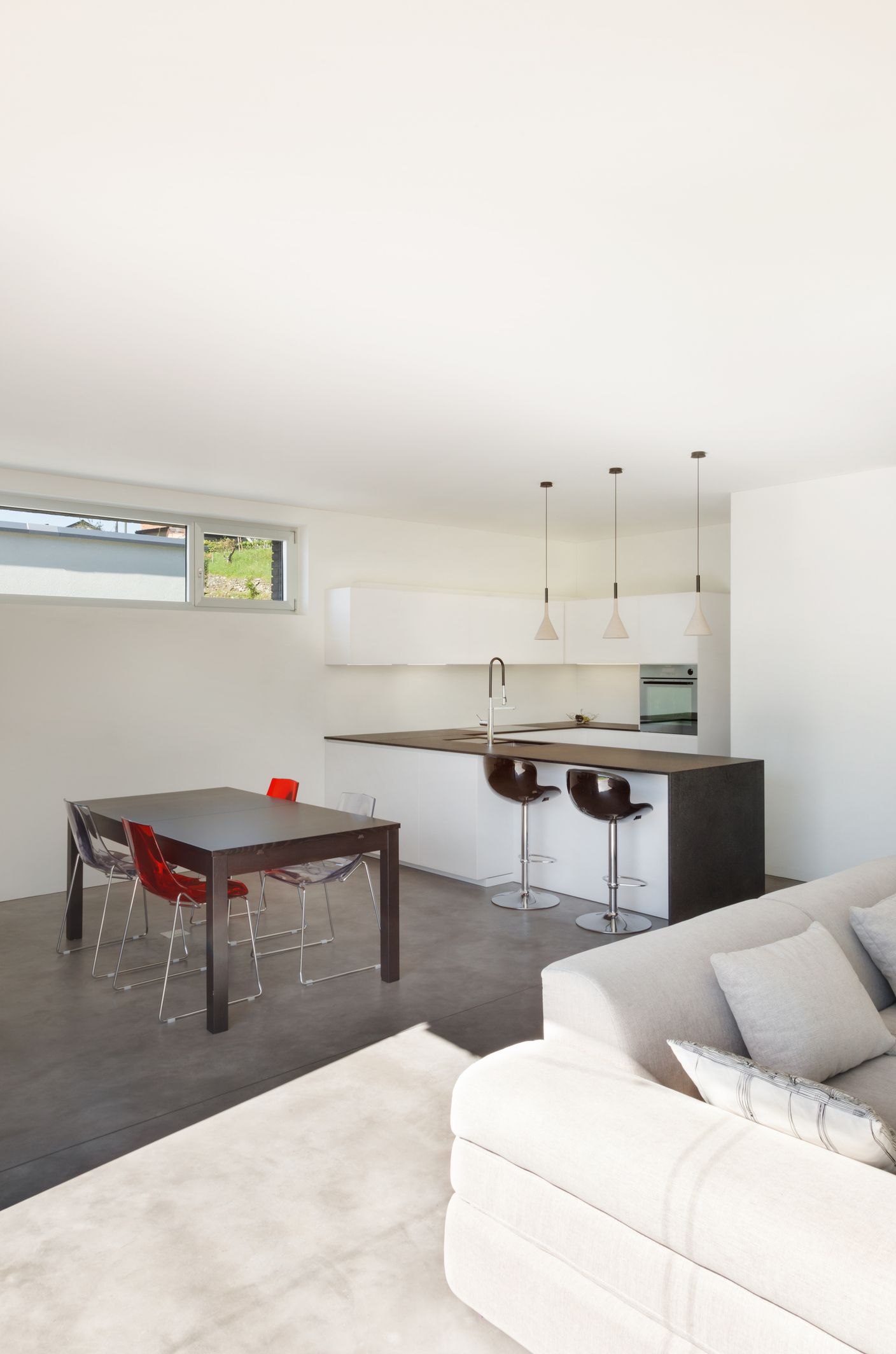 Modern open-plan kitchen and dining area with a table, chairs, and a kitchen island.