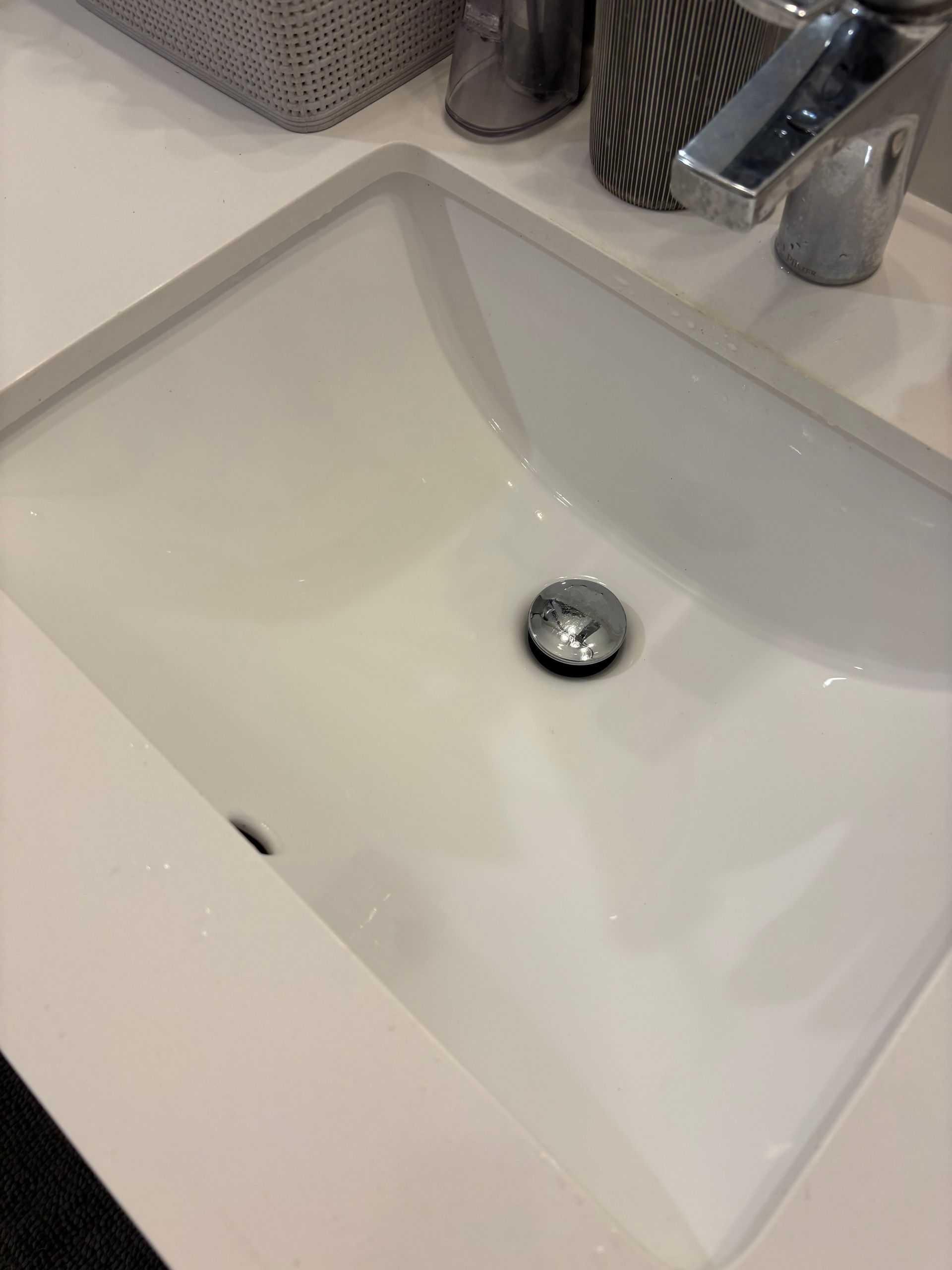 Modern kitchen with wooden cabinets, island, stainless steel appliances, and a conservatory.