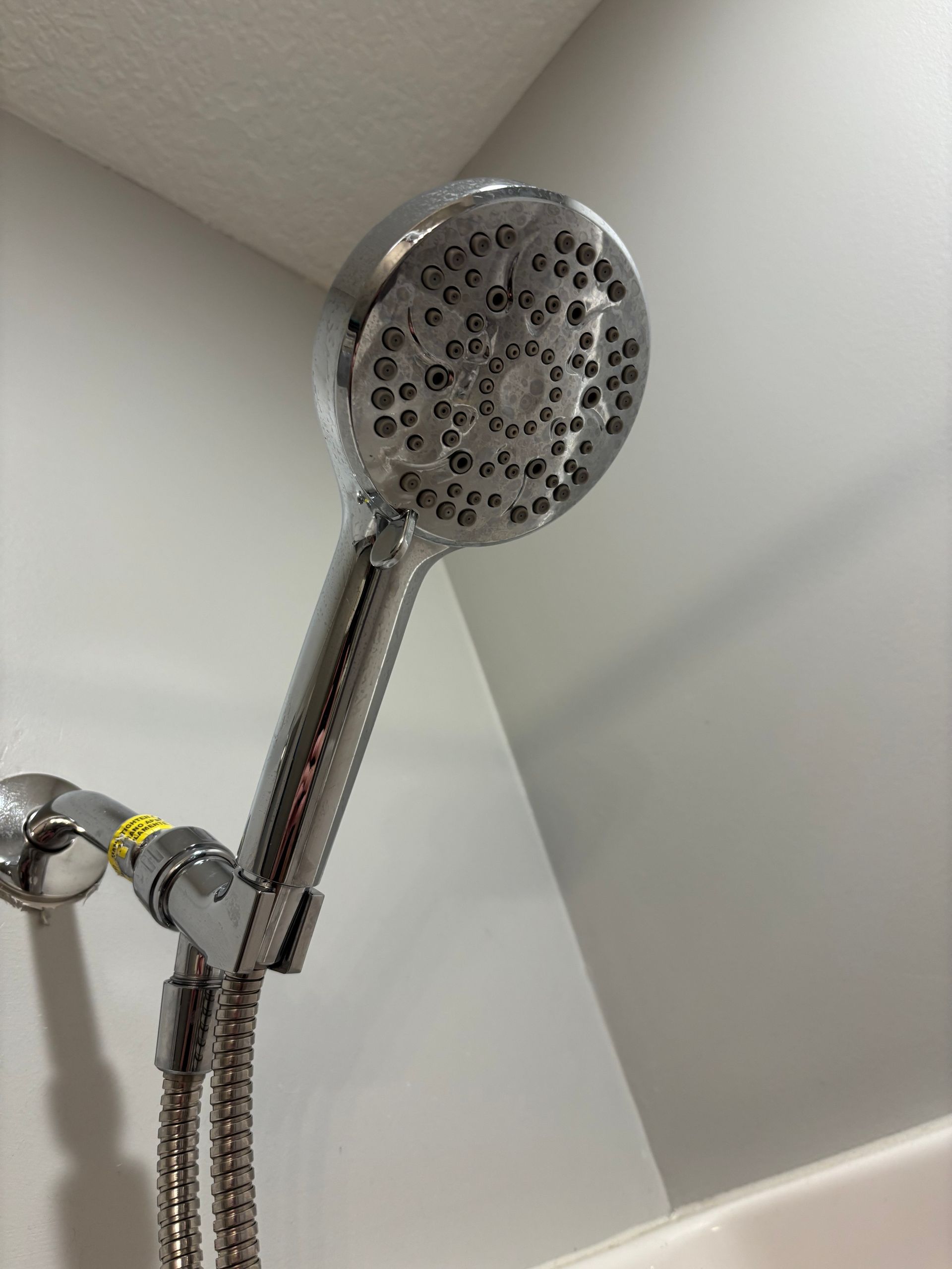 Woman in mask and gloves gives thumbs-up as person cleans office desk.