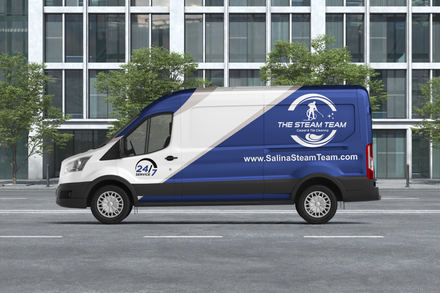 a blue and white van is parked in front of a building .