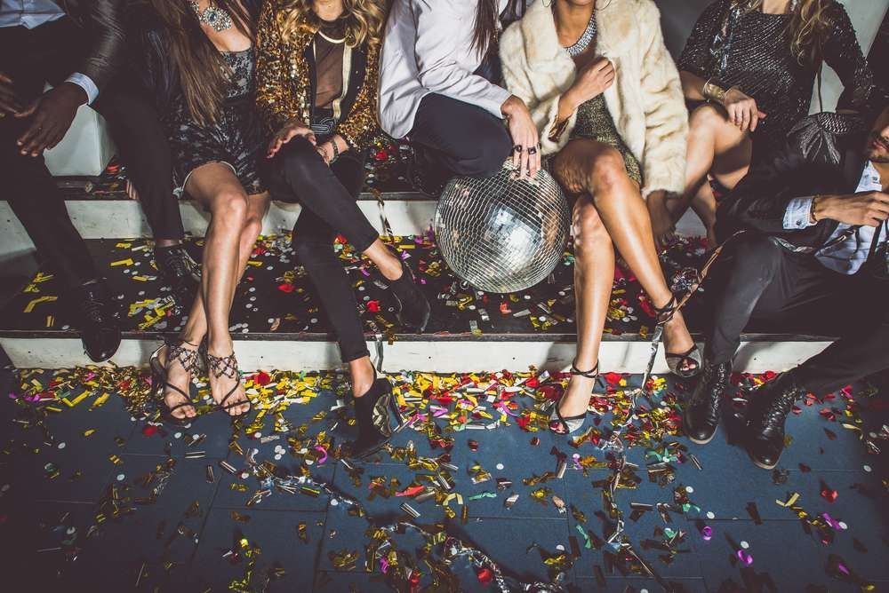 A Group Of People Are Sitting On A Couch At A Party Holding A Disco Ball — HYP-E-VENTS In Spence, ACT