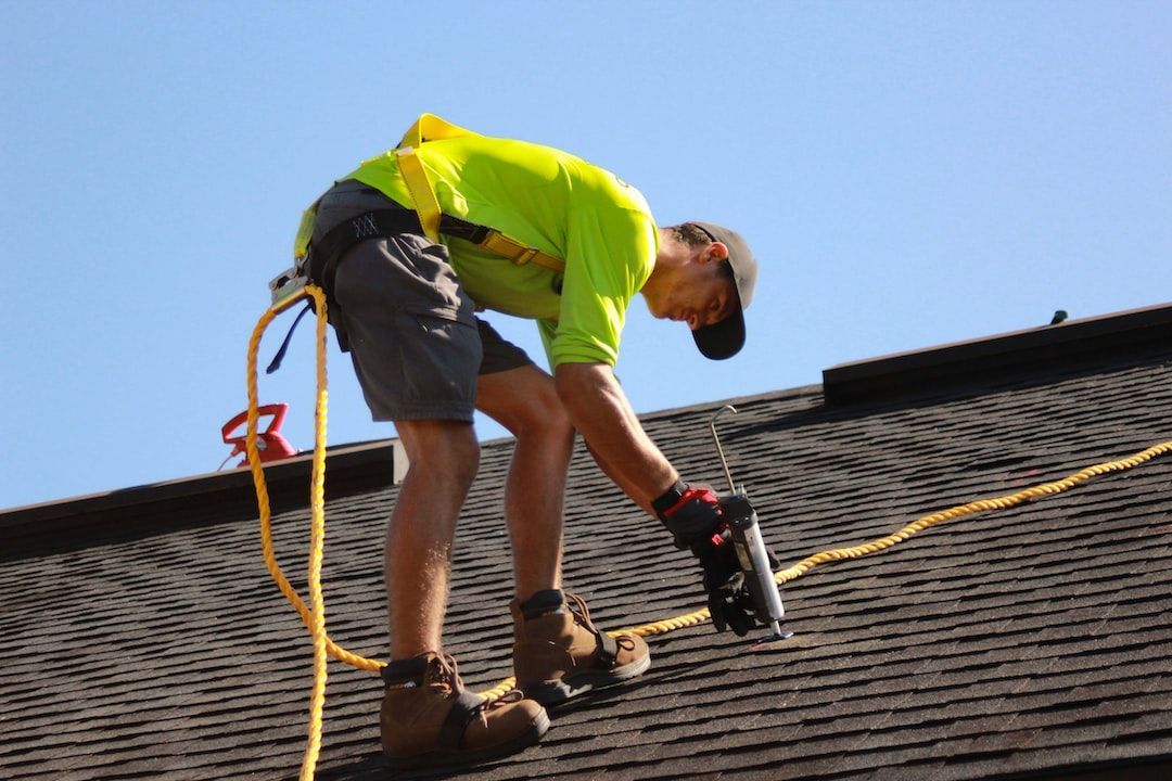 A man is working on the roof of a building.