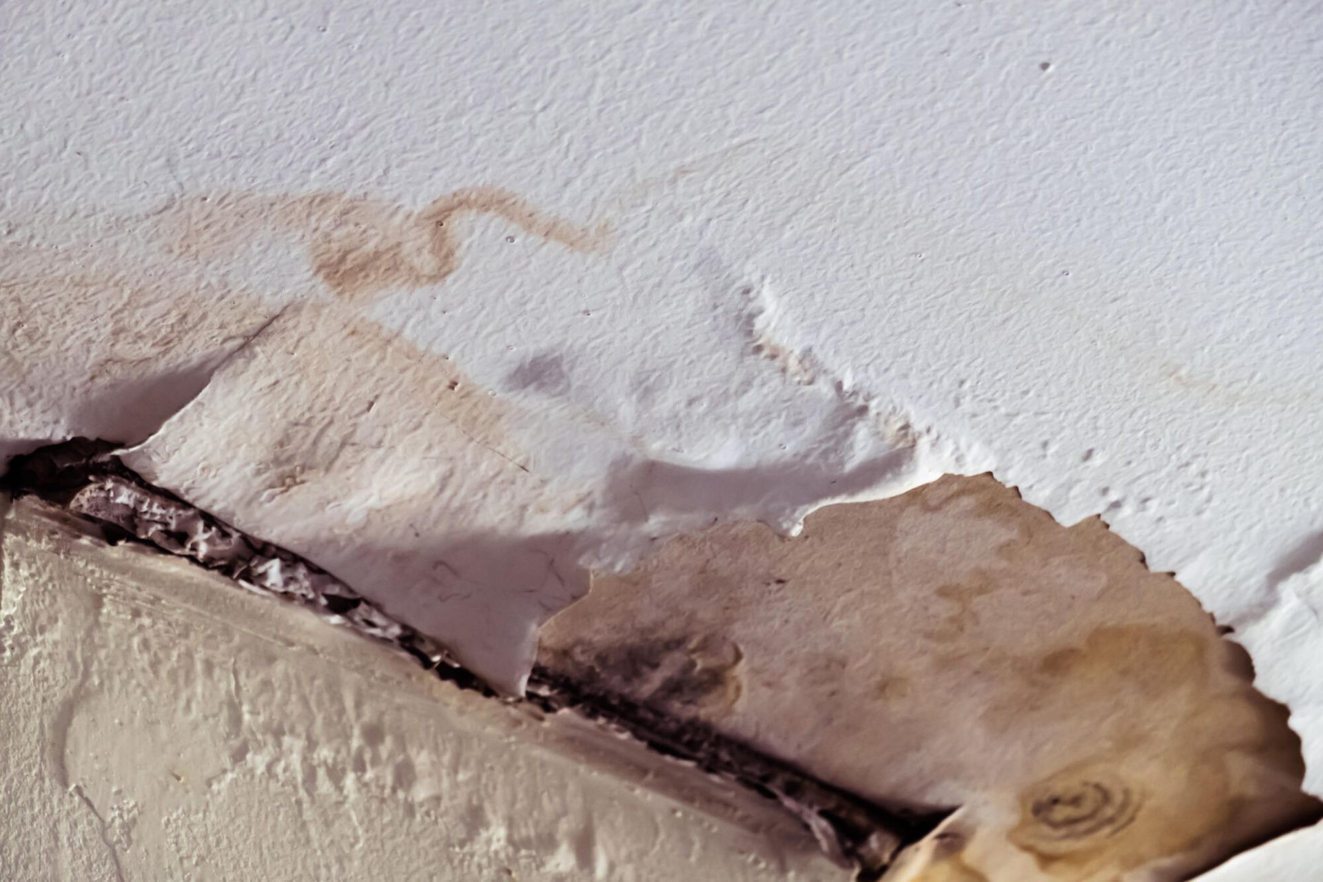 A close up of a white wall with a stain on it