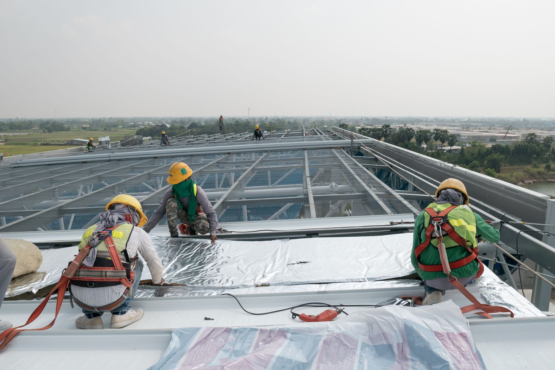 men working on a commercial roof