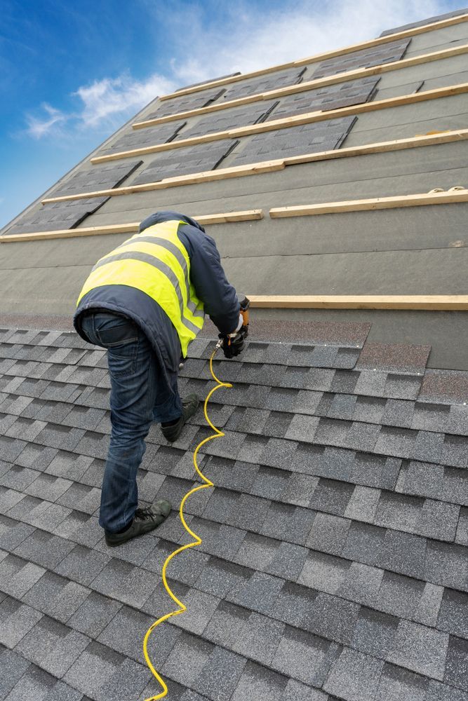 a man is working on a roof with a tape measure .