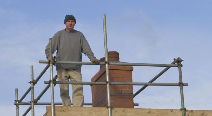 Man on roof scaffolding