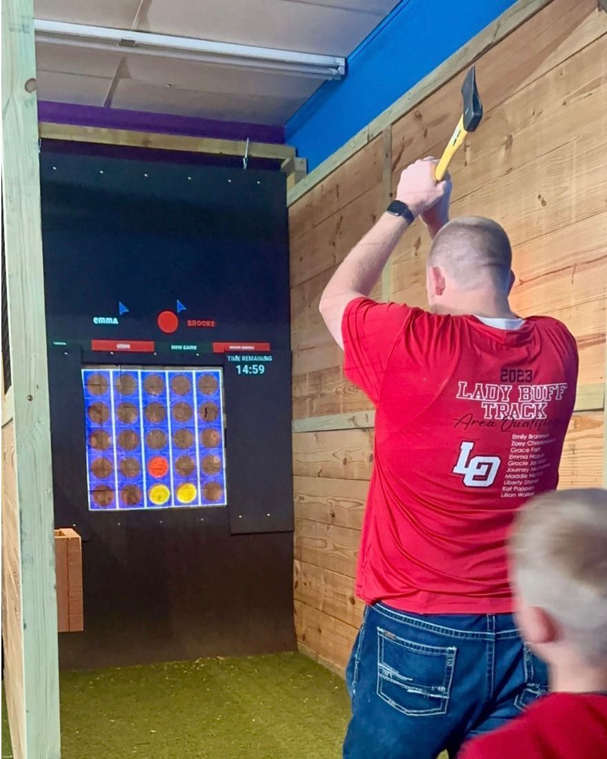 A man in a red shirt with the letter l on it