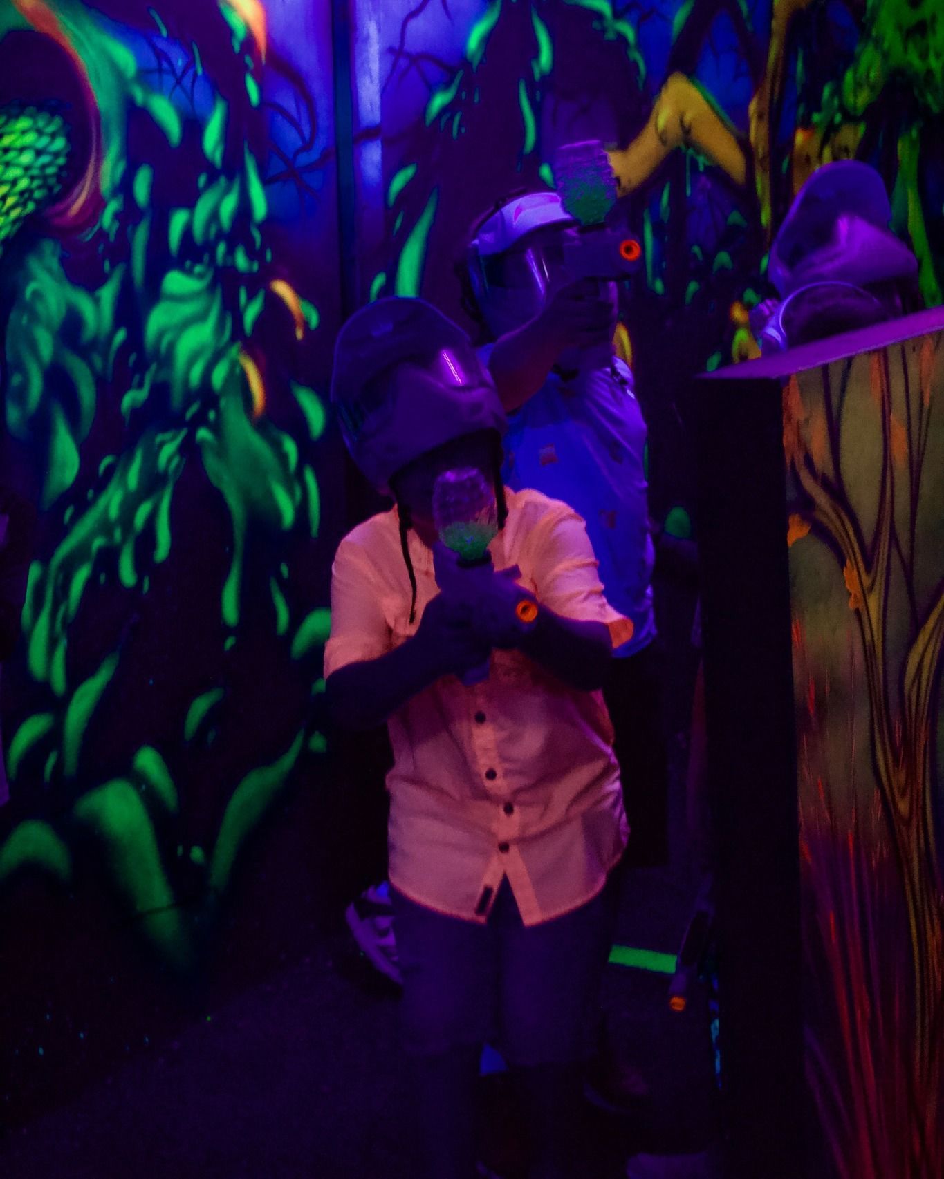 A man is standing in front of a glow in the dark wall