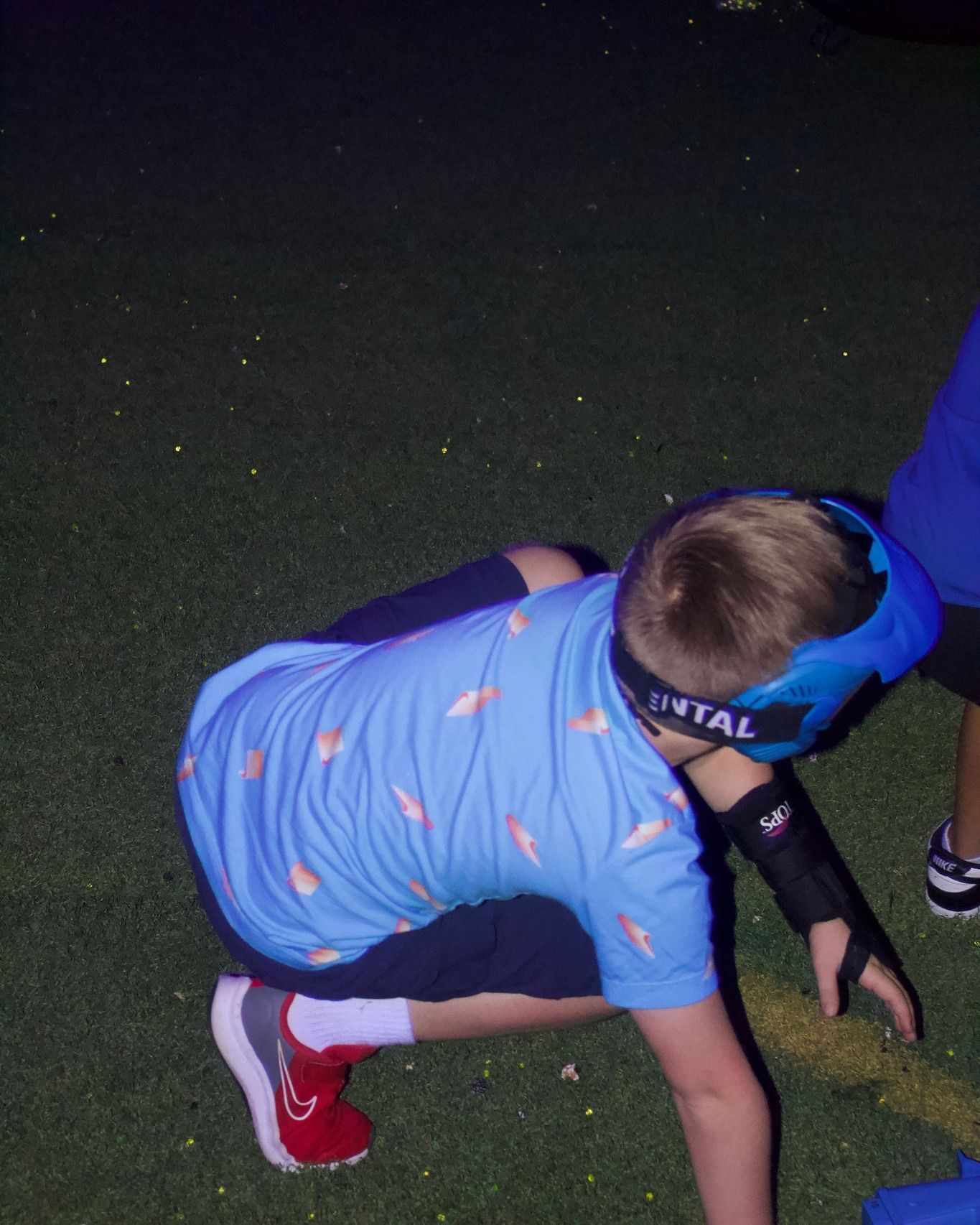 A boy wearing a headband that says dental on it