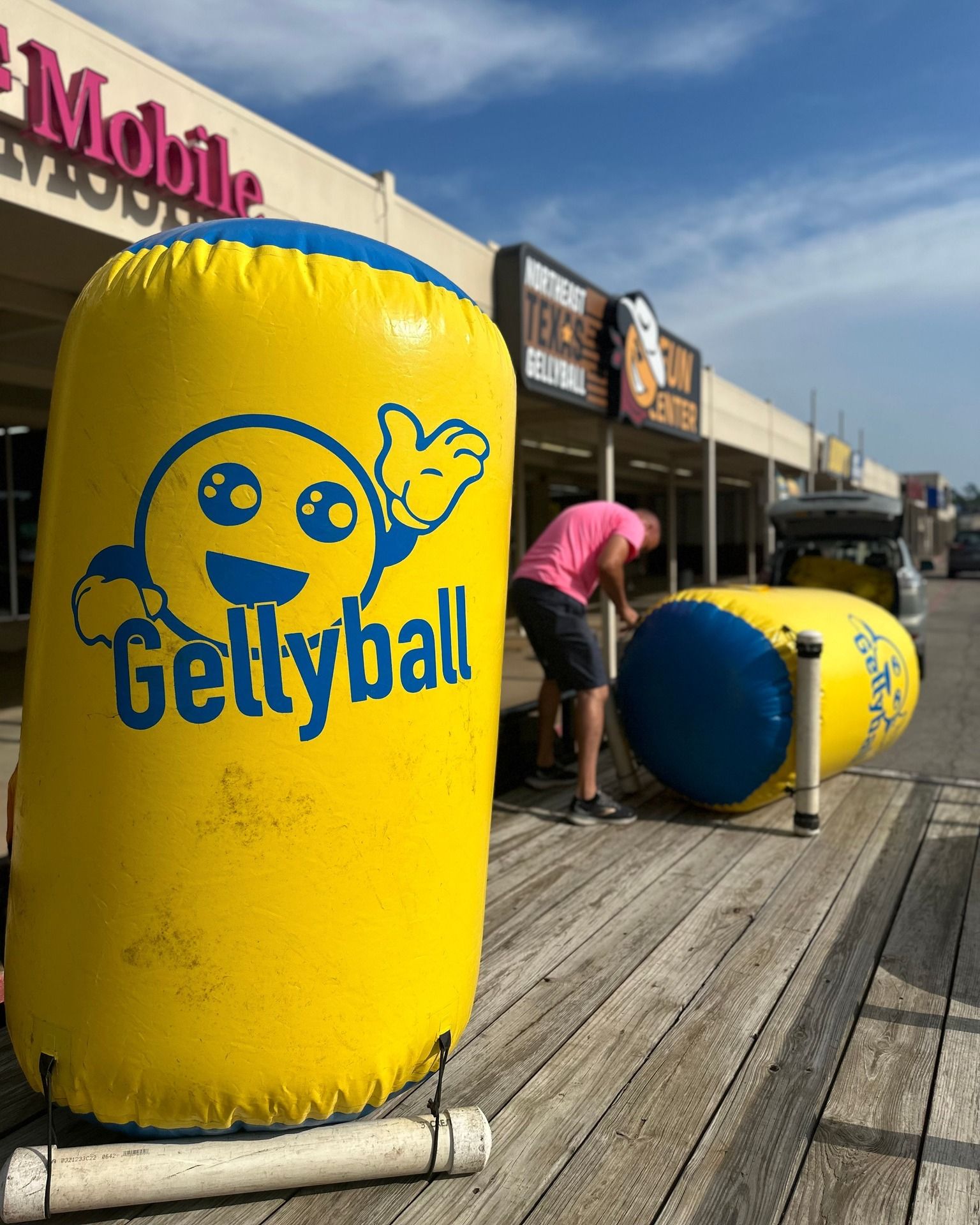 A man is standing next to a yellow gettyball