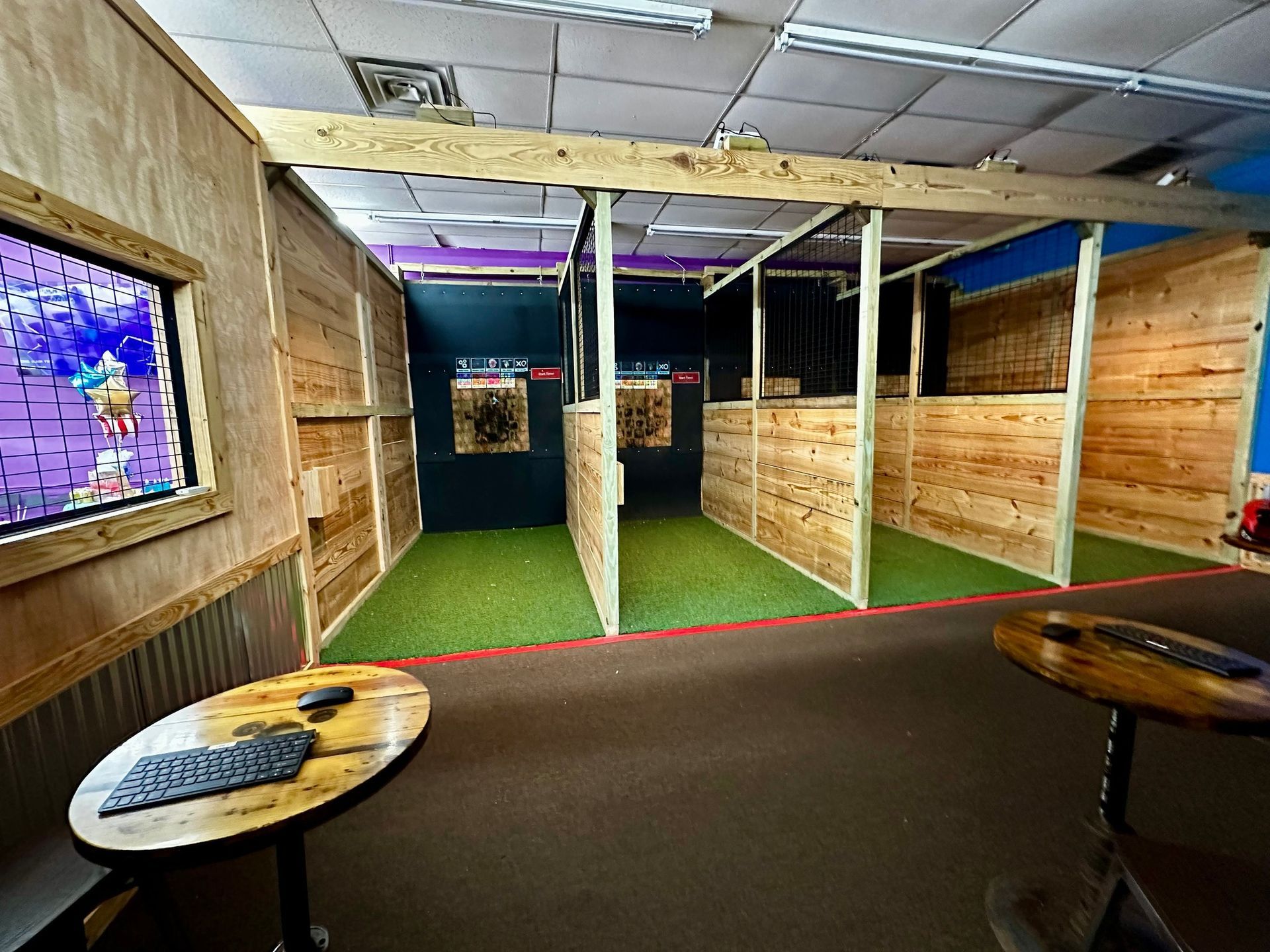 A room with wooden walls and a table with a computer on it.