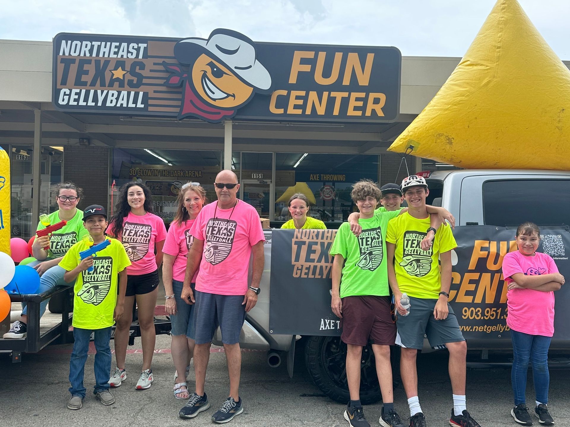 A group of people standing in front of a fun center
