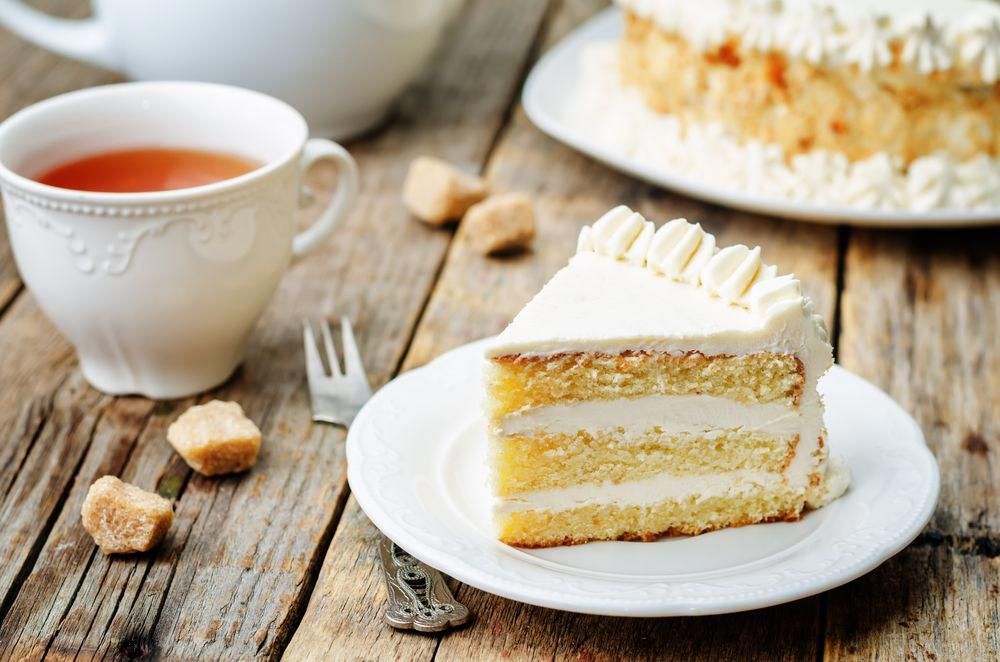 Cream Cake With Tea On A Wooden Table