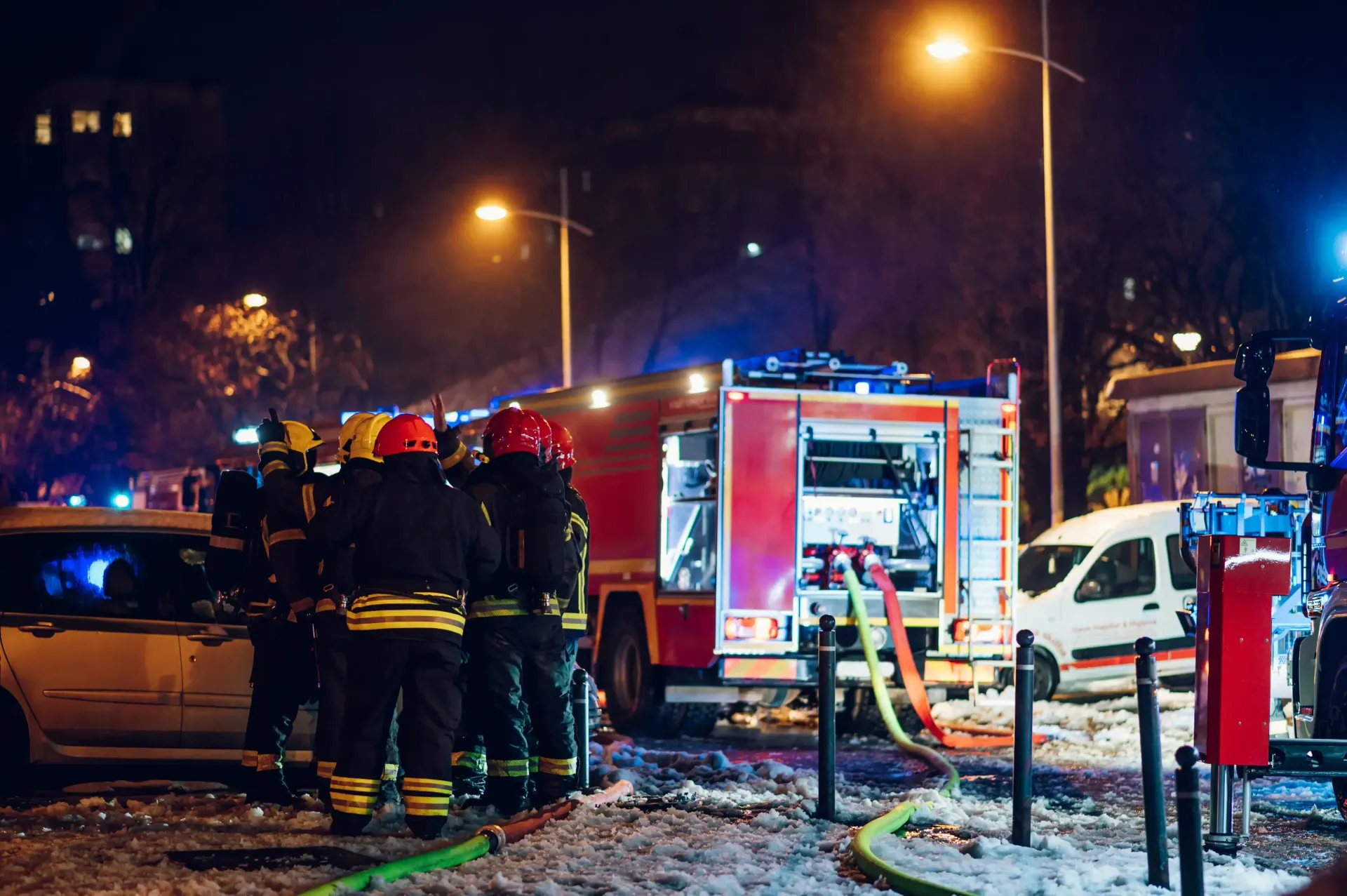 two red machines are sitting on a white floor next to each other .