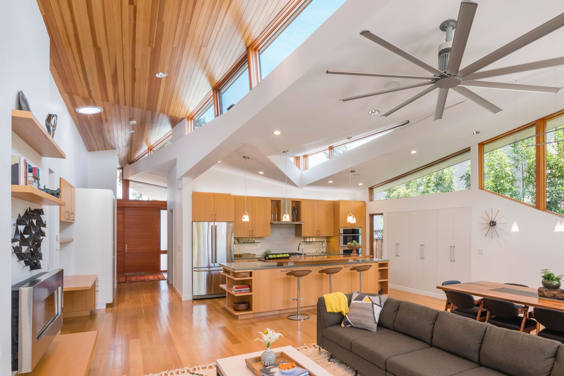 Dramatic angled clerestory and windows softly illuminate the great room