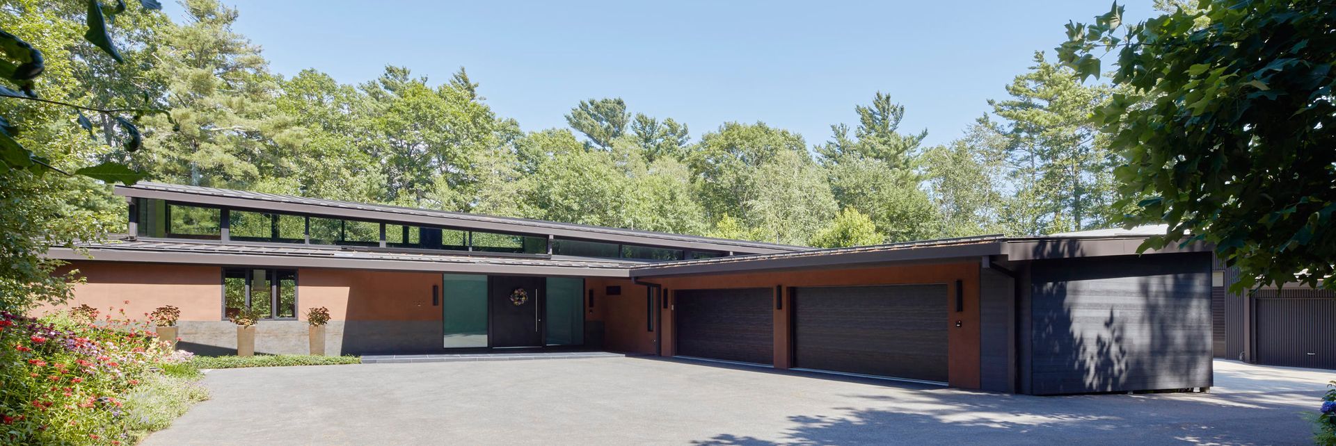 The entry court leads to the front door and four car garage