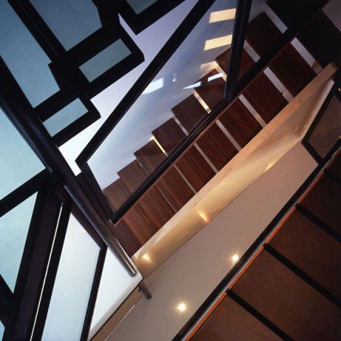 Open floating stairs with view of the entry foyer