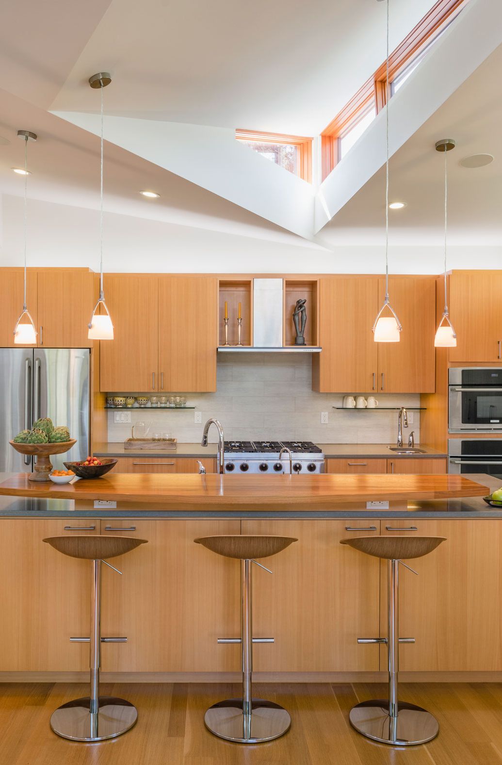 The kitchen cabinetry is clean & warm