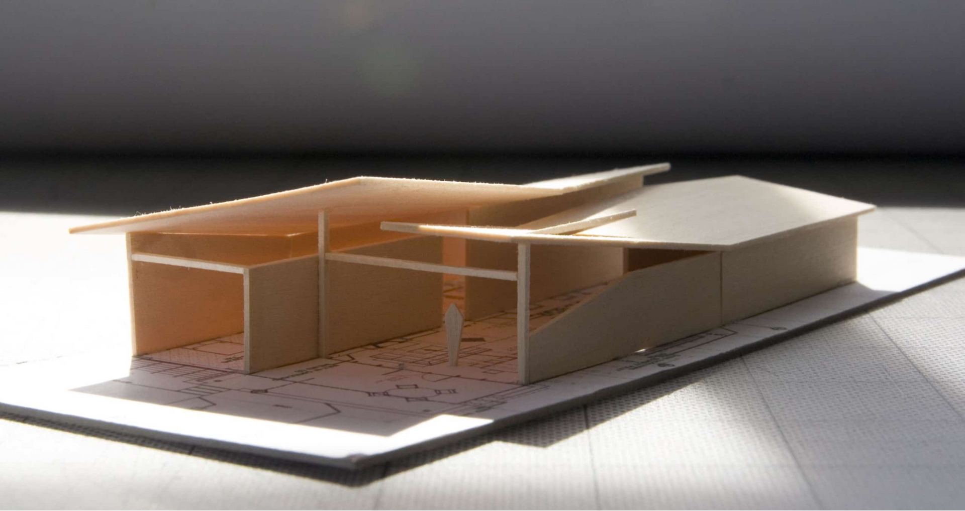 A study model of a house with a split roof design