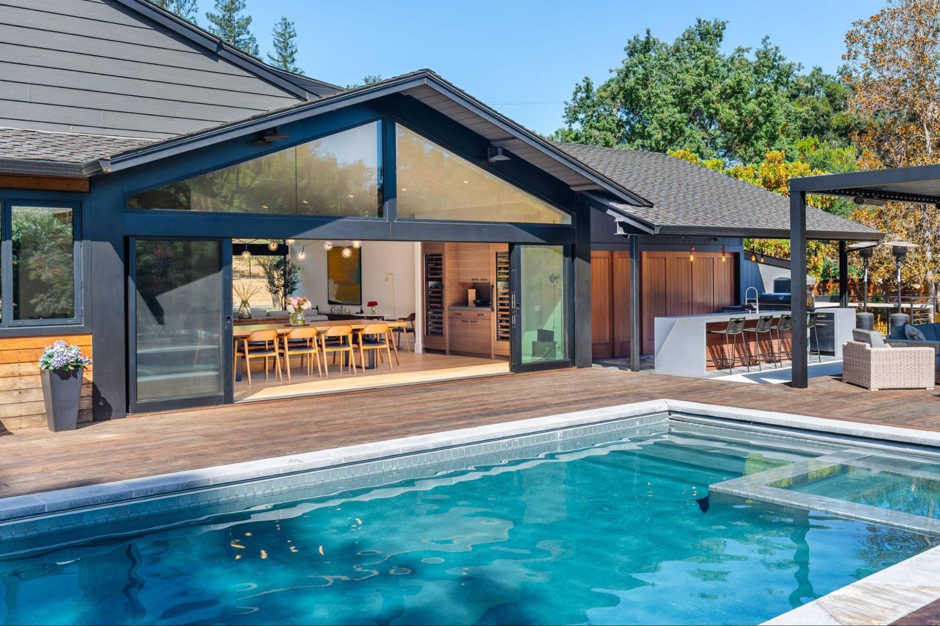 The great room opens to the pool deck and outdoor kitchen 