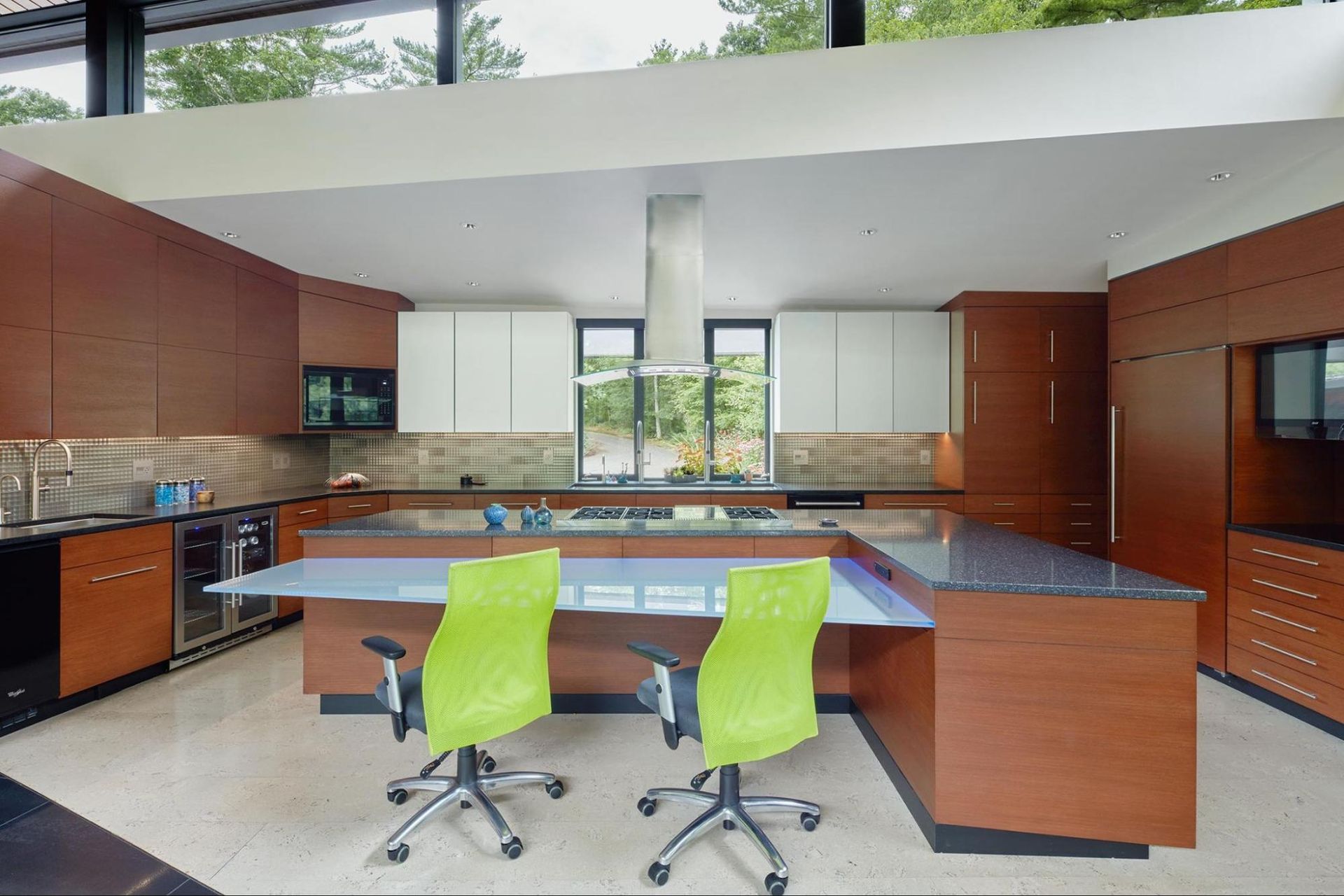 A kitchen with a large island and his and her sink faucets