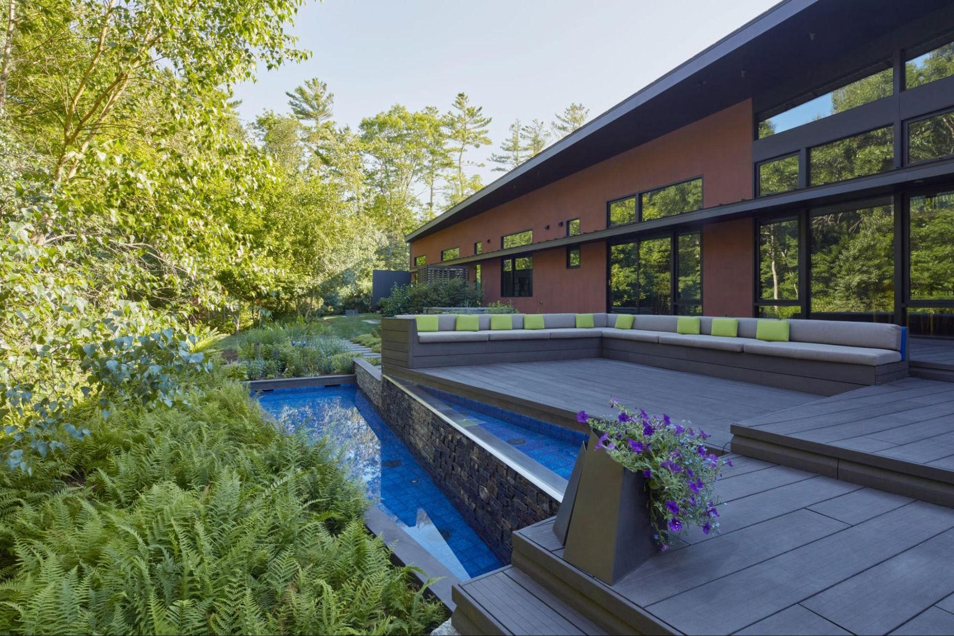 Angled reflecting pools with waterfall edge at the back deck 