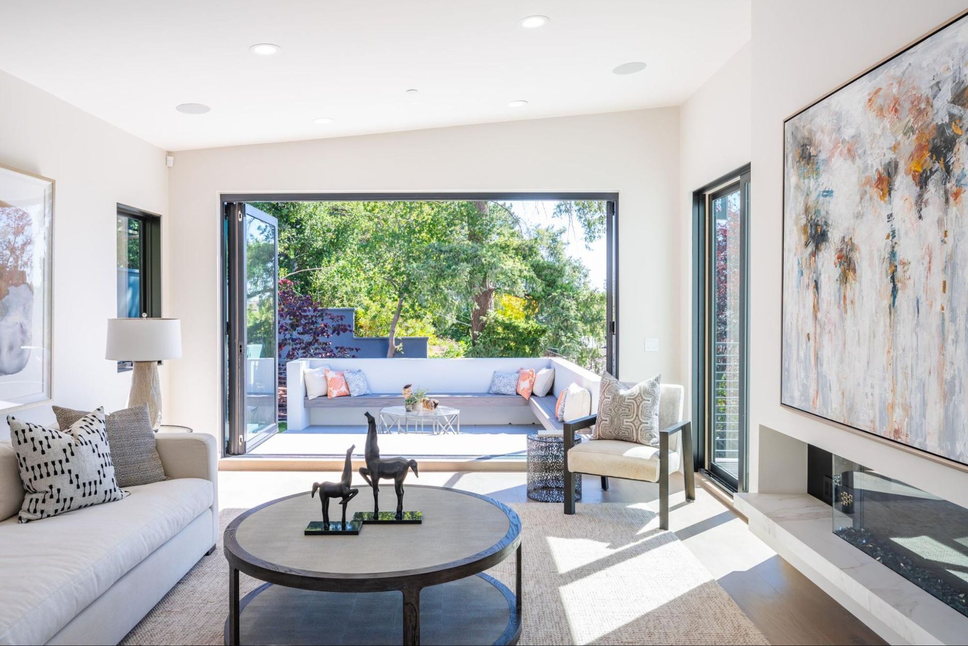 The family room has a linear gas fireplace and opens to an outdoor seating area