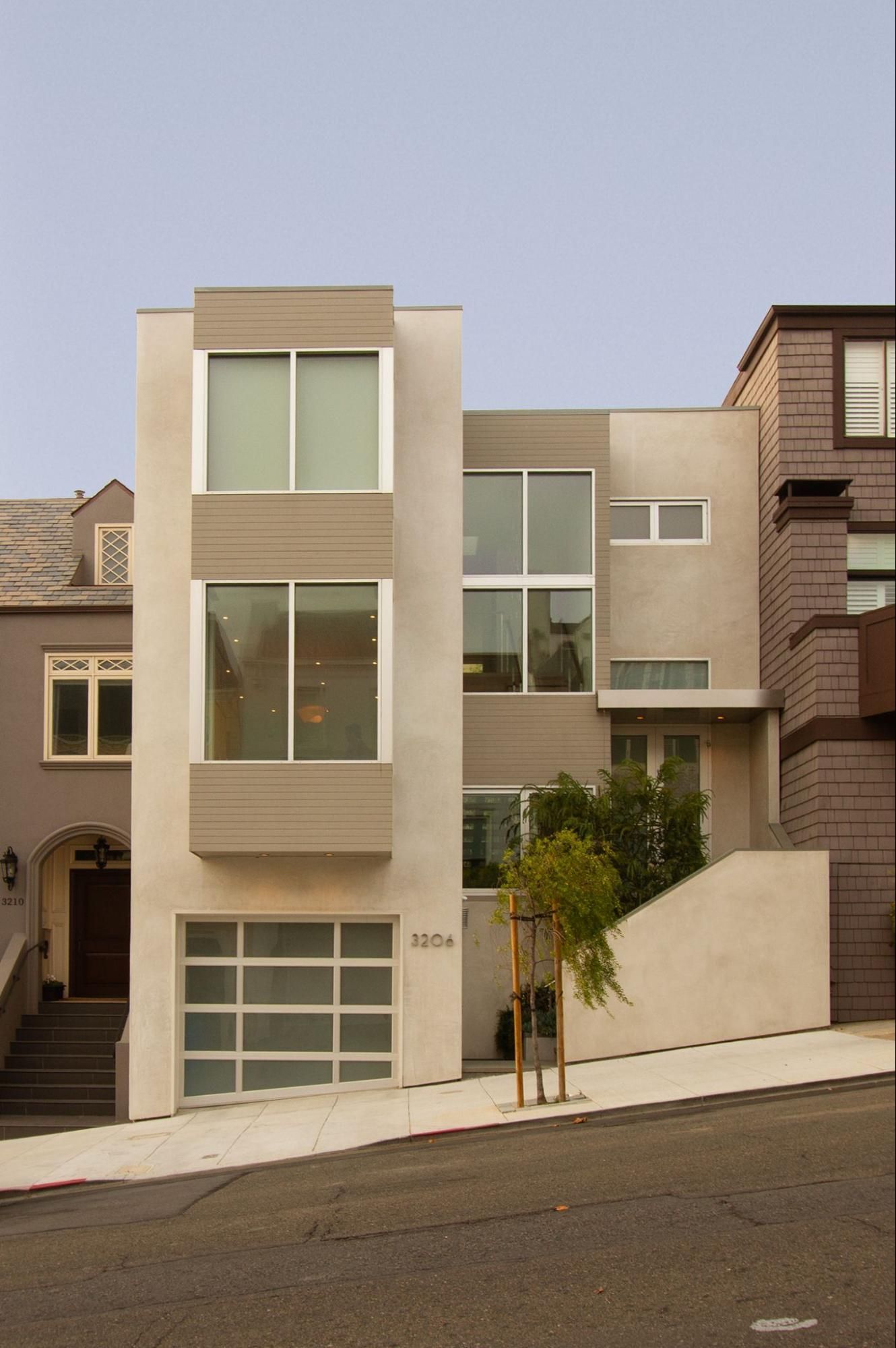 The elegant front facade has clean lines and neutral tones