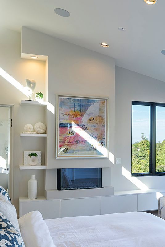 Clerestory windows illuminate the fireplace in the master bedroom