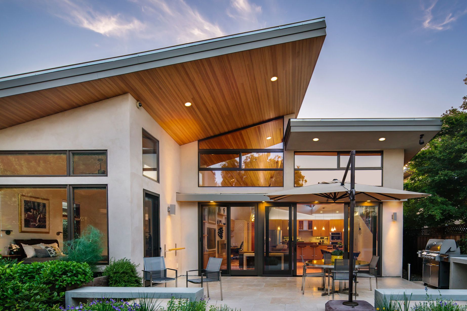 The glassy rear facade of a contemporary ranch style home