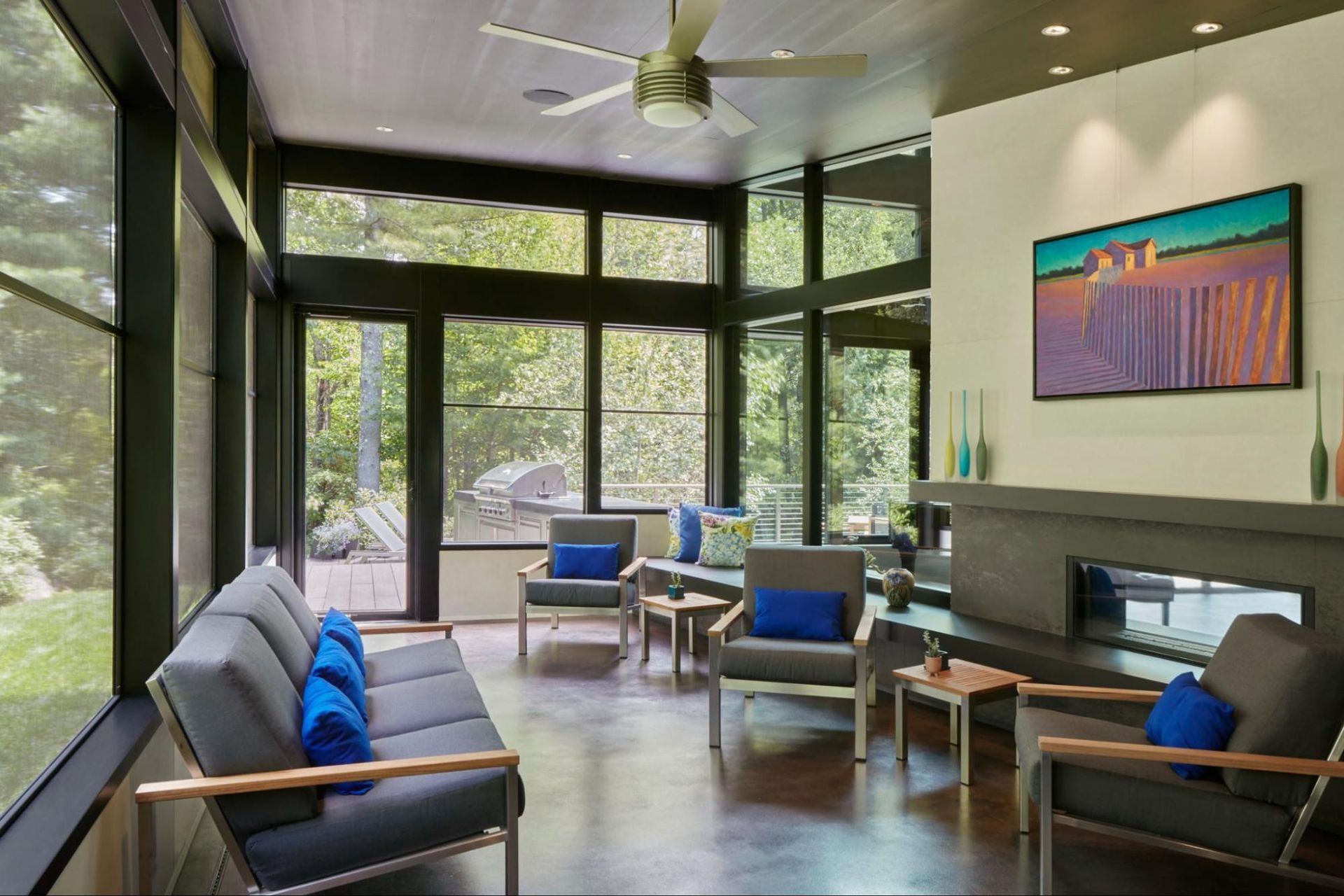 A modern screen porch with a two-sided fireplace 