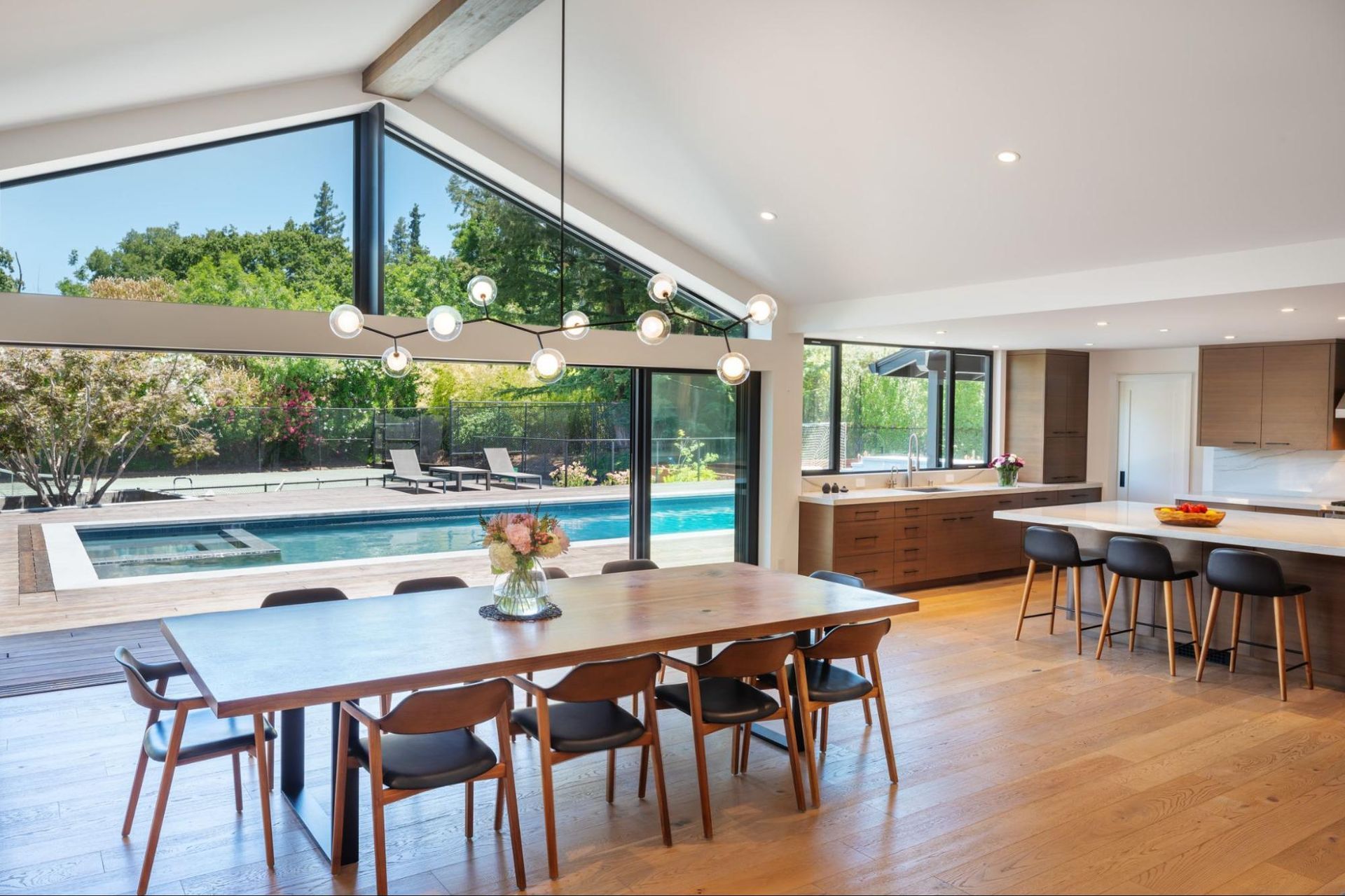 The dining room and kitchen have views of the backyard