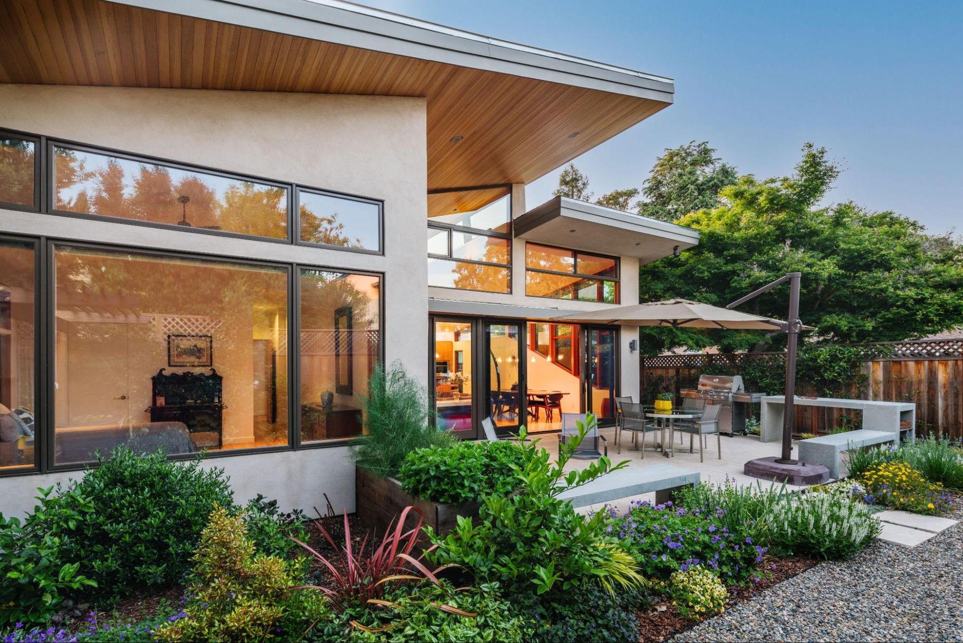 A modern house with a split roof design and a lot of windows 