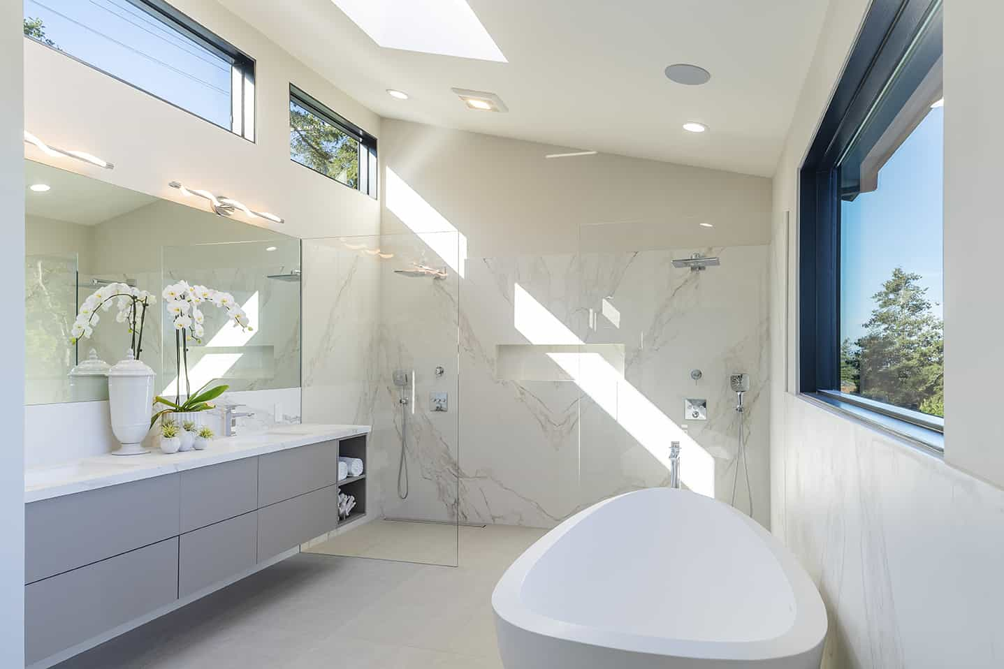 The master bathroom has a vessel tub, two-person shower and generous vanity