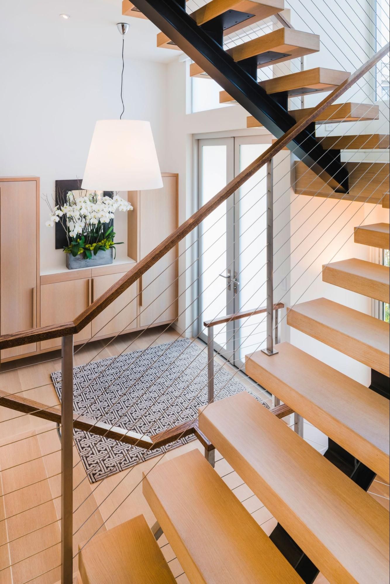 The open stairs overlook the new entry foyer