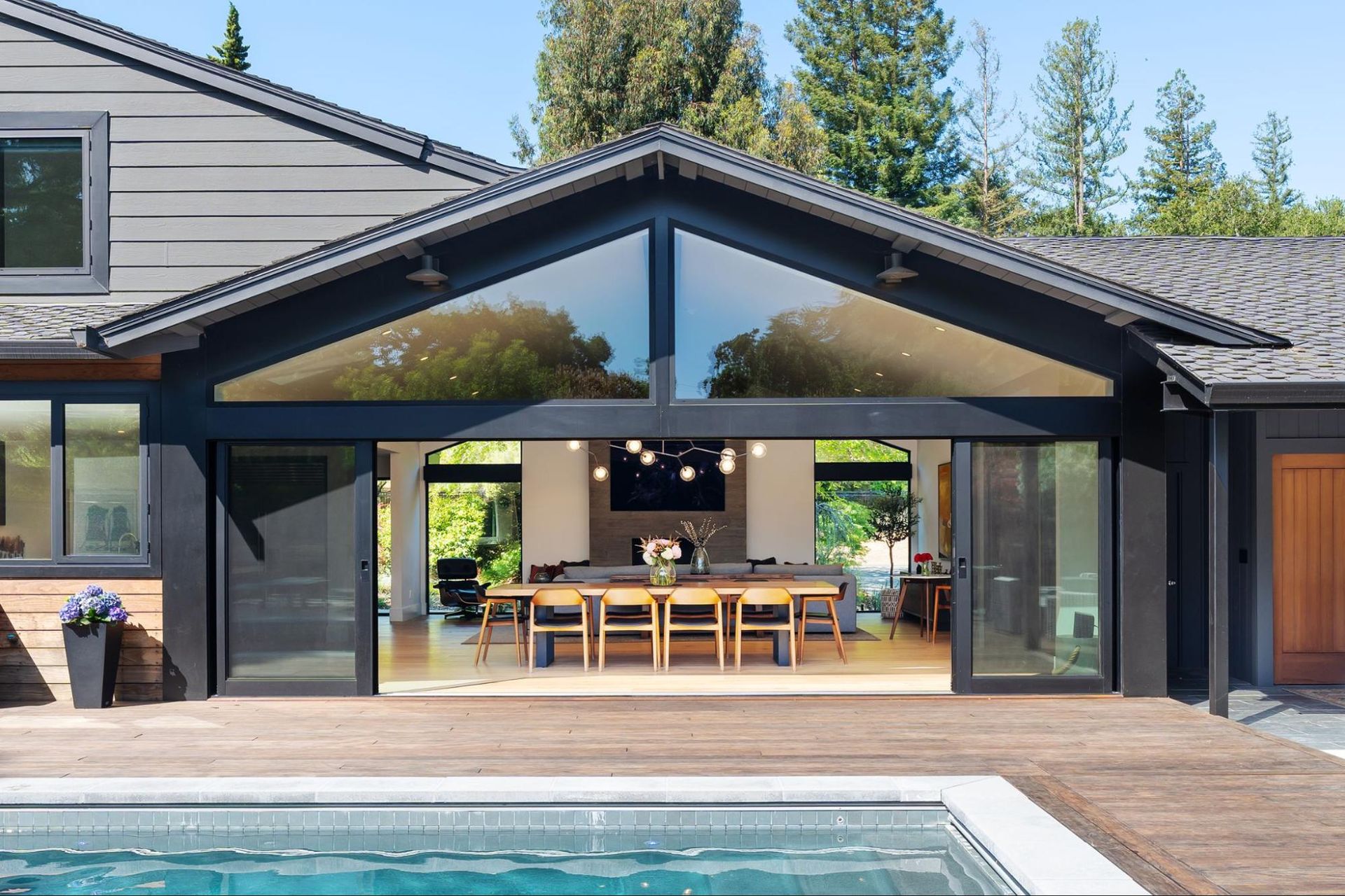A newly vaulted great room opens to the swimming pool deck