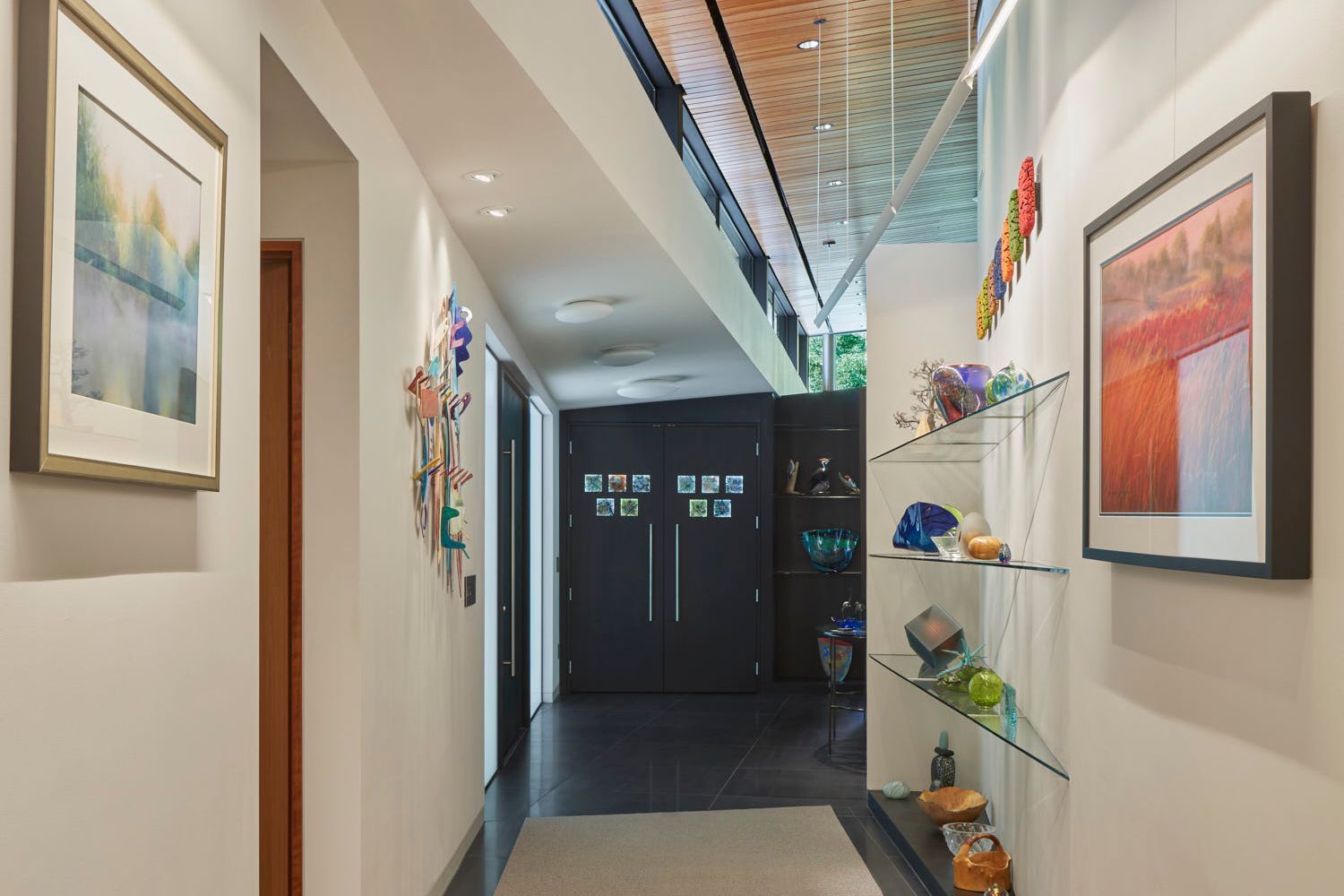 Entry foyer coat closet and glass display shelves