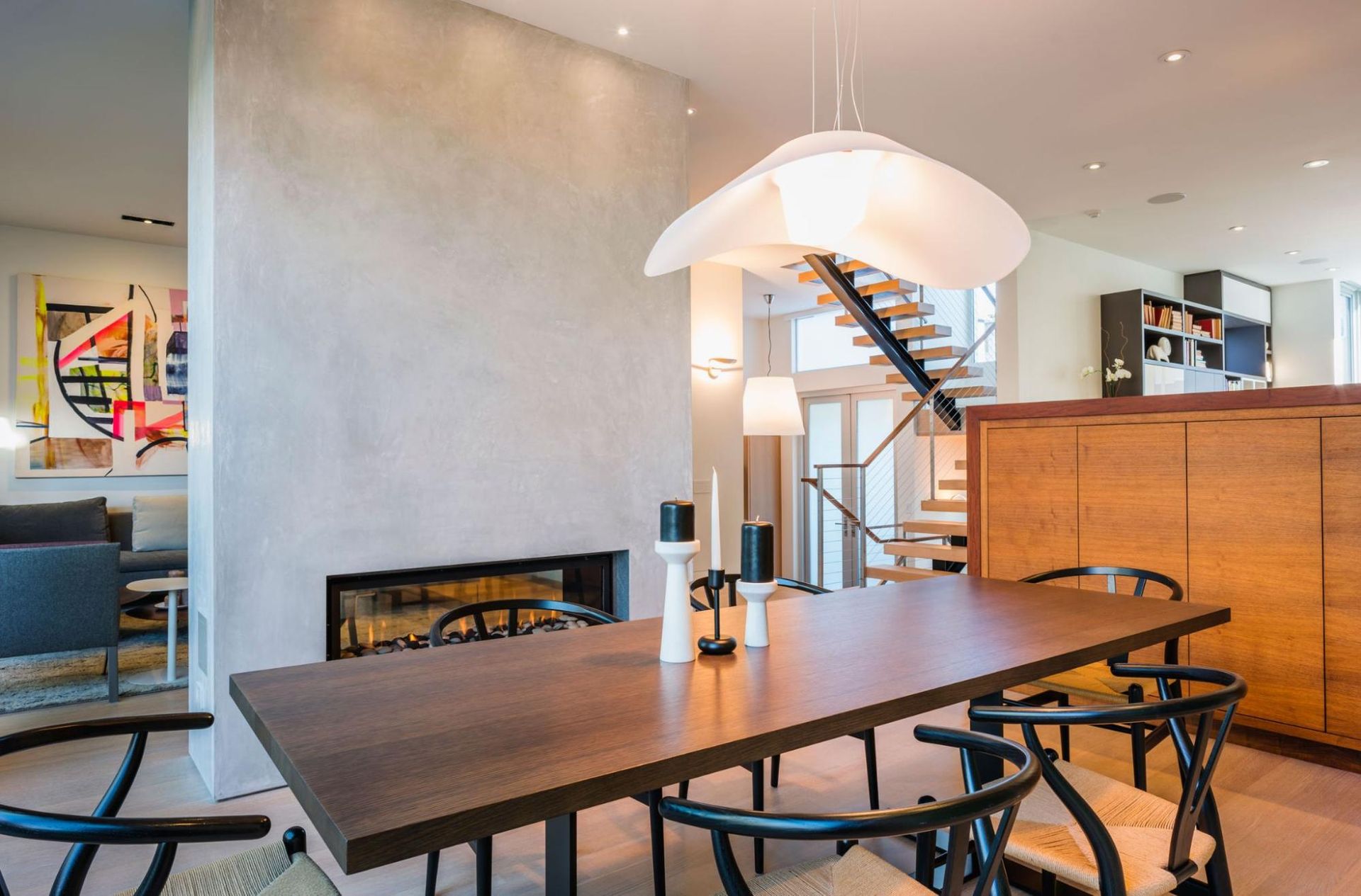 A two-sided fireplace separates the dining and living areas