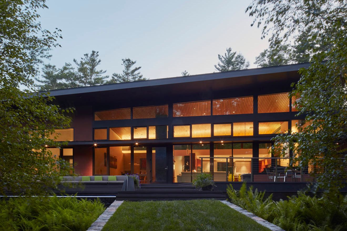 Modern house in the woods seen through the trees