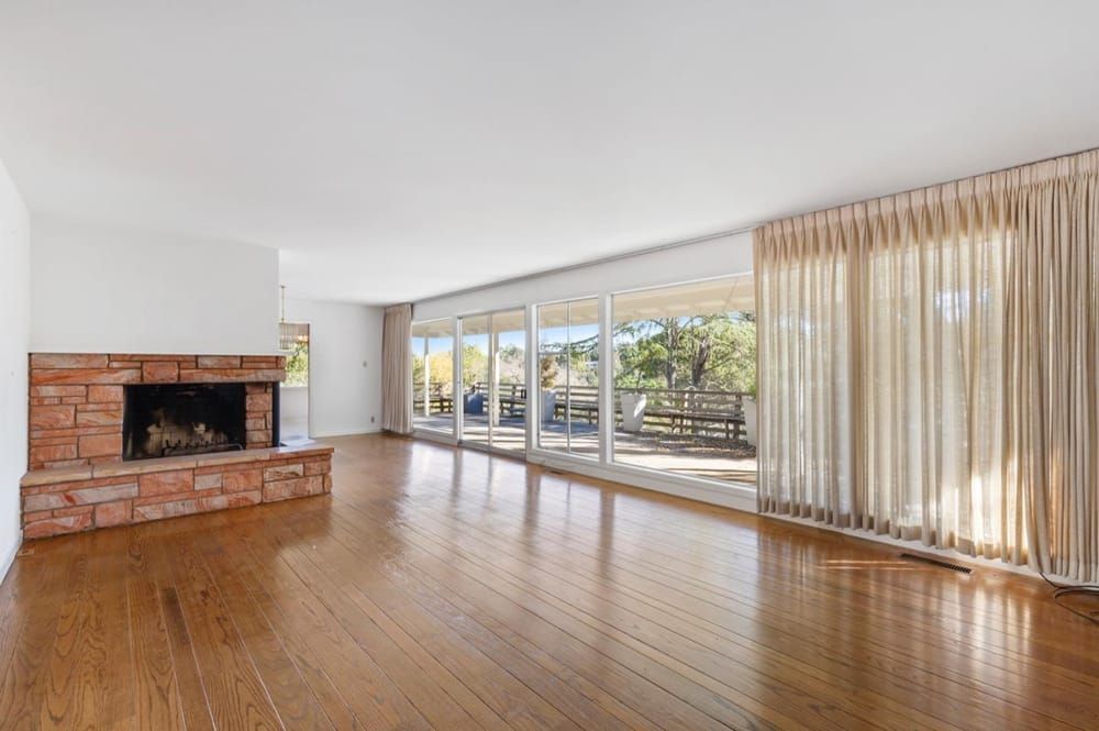 The existing living room had a brick fireplace and flat ceiling